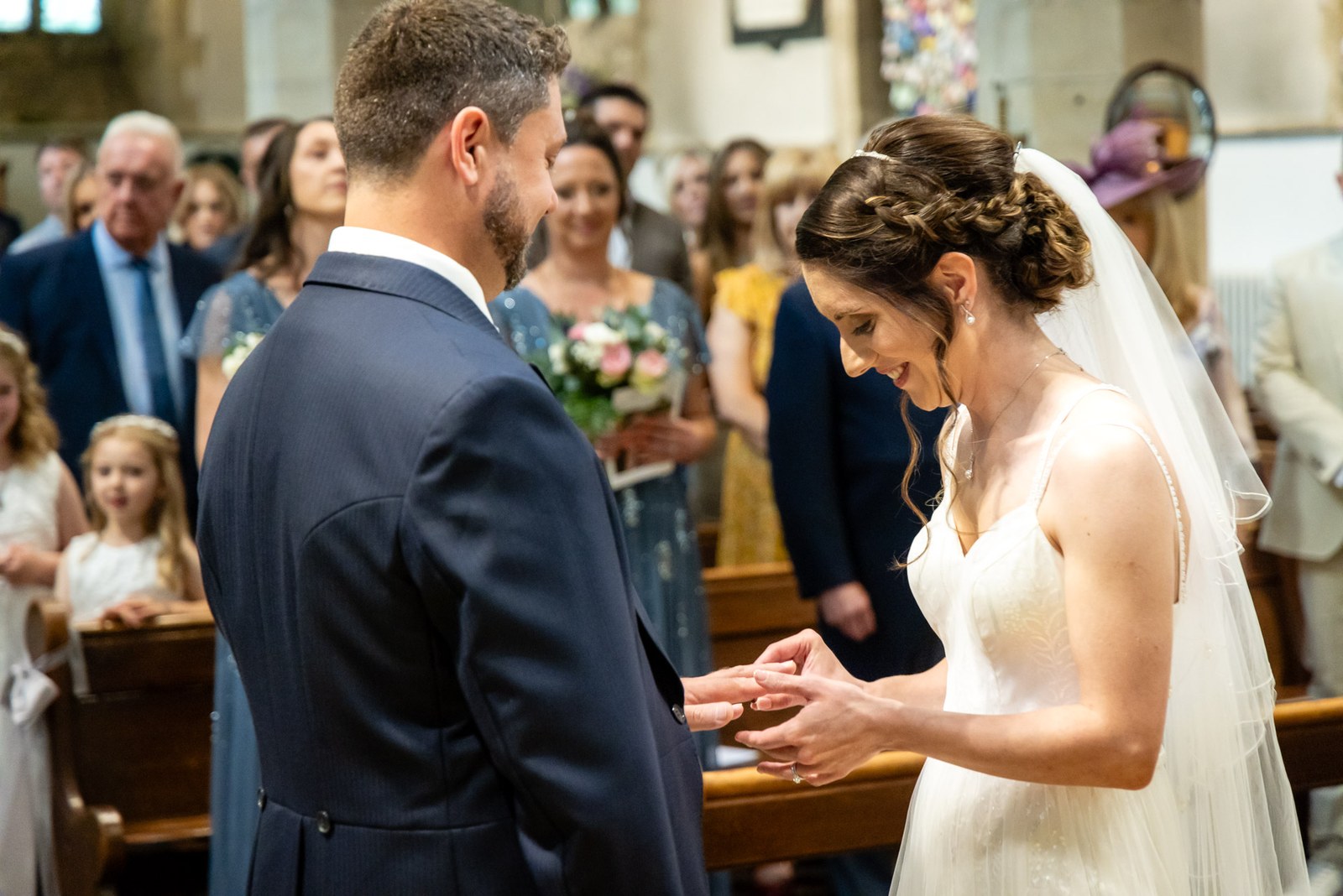 The bride slides the ring onto the groom's finger at the altar