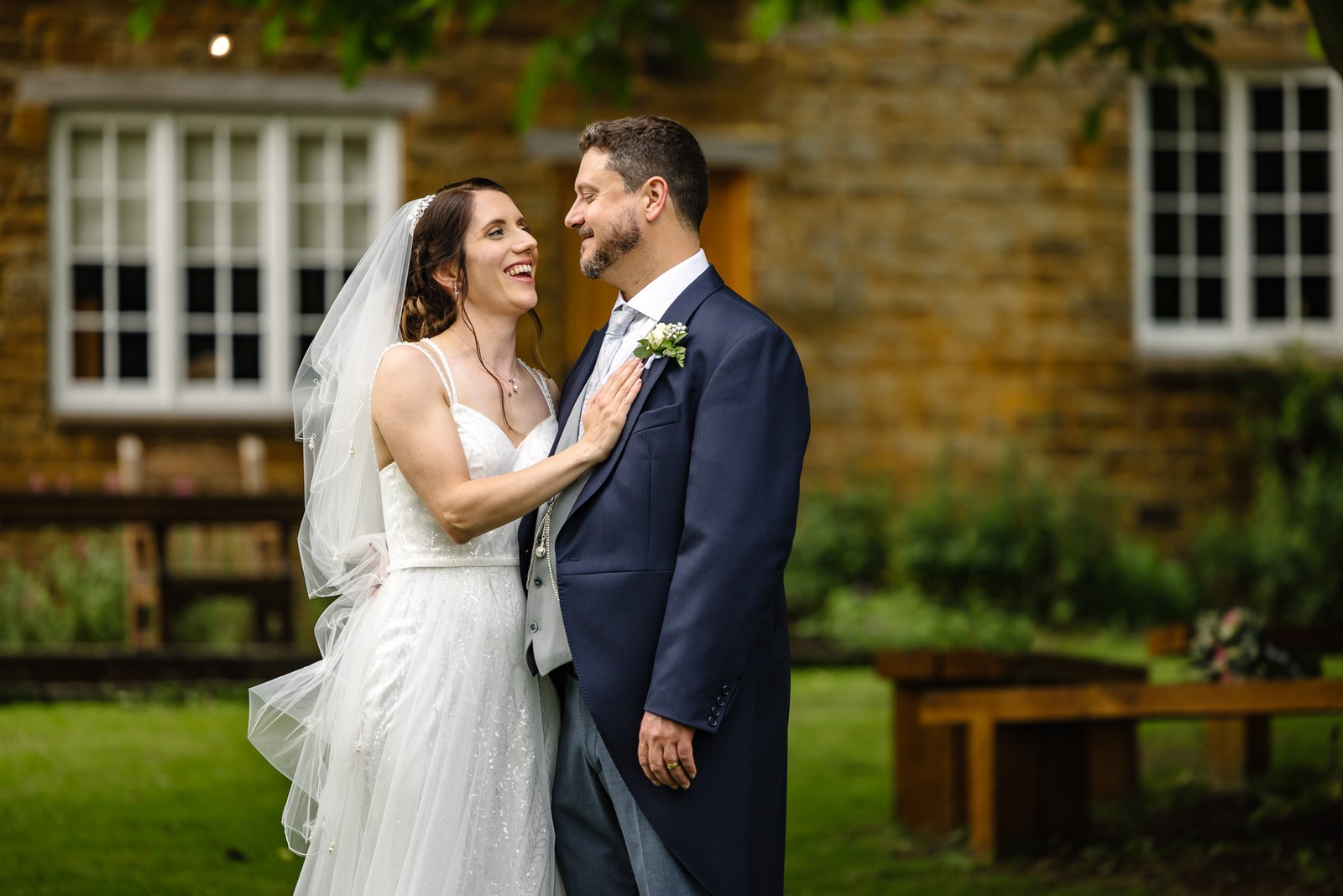 The couple share a quiet moment before the honey-stone farmhouse at Crockwell Farm