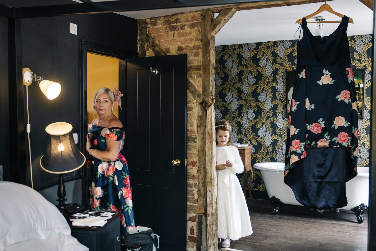The mother of the bride and a flower girl in a room with a roll-top bath