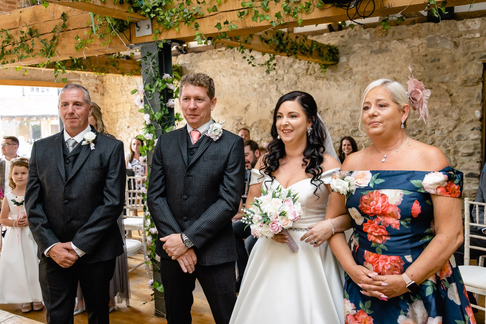 The bride joins the groom at the front, her mother and the best man either side