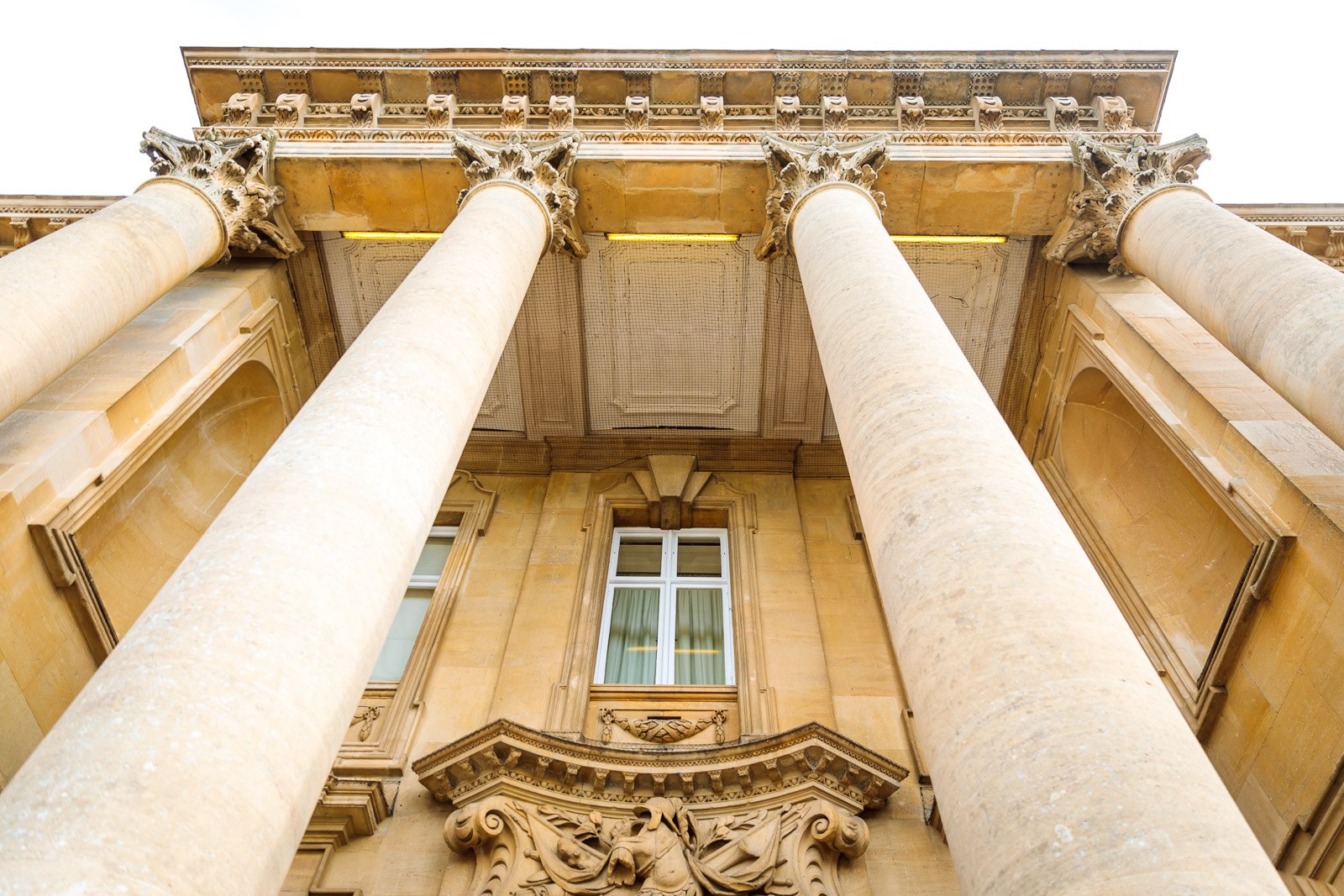 Low-angle view of the carved stone columns and portico of Heythrop Park