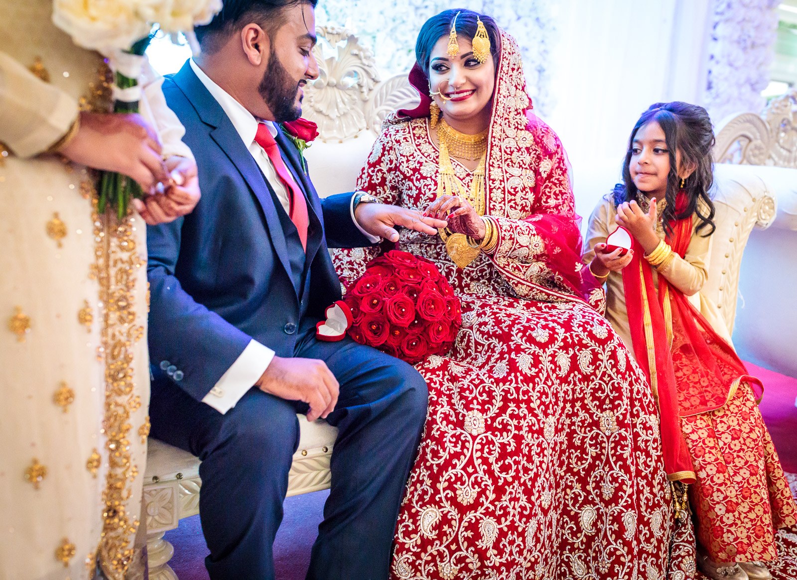 The bride smiles during the ring exchange on the stage