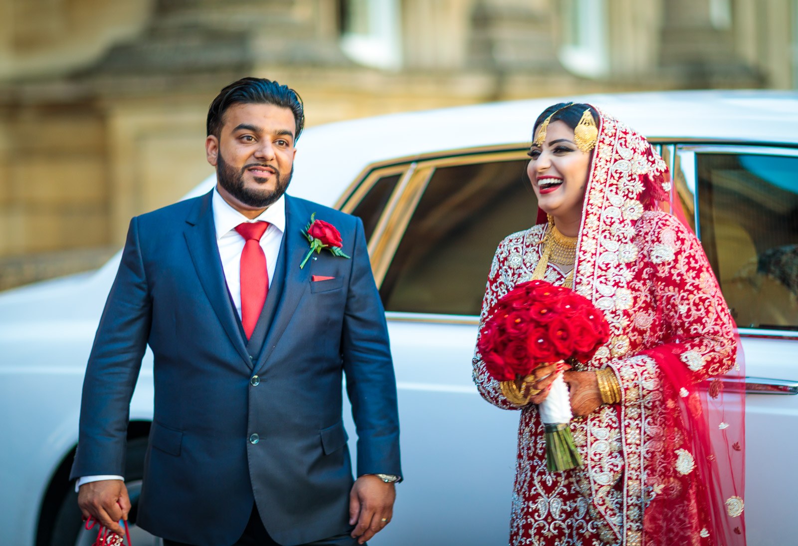 The couple pose beside a white Rolls-Royce outside Heythrop Park