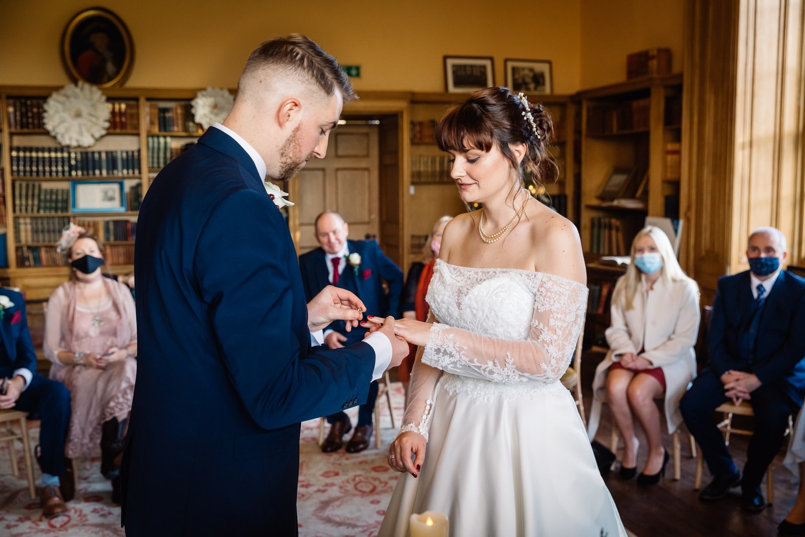 The groom slides the ring onto the bride's finger during the ceremony