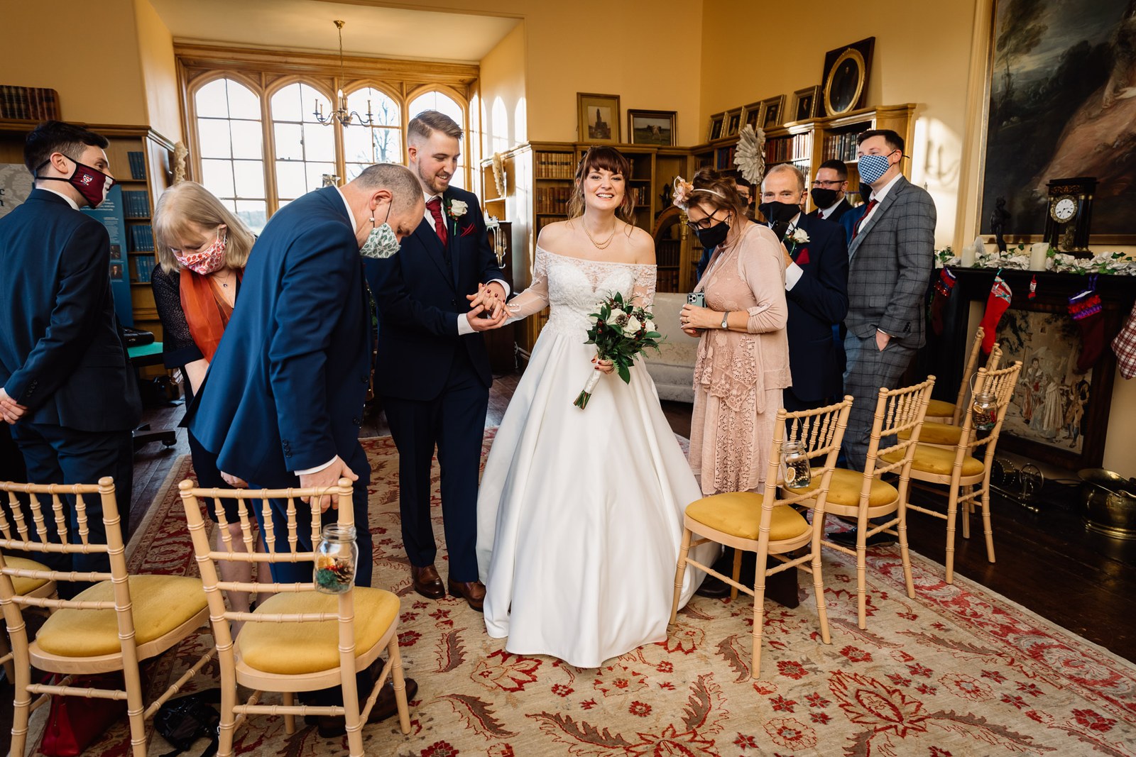The newlyweds walk back down the aisle past standing guests