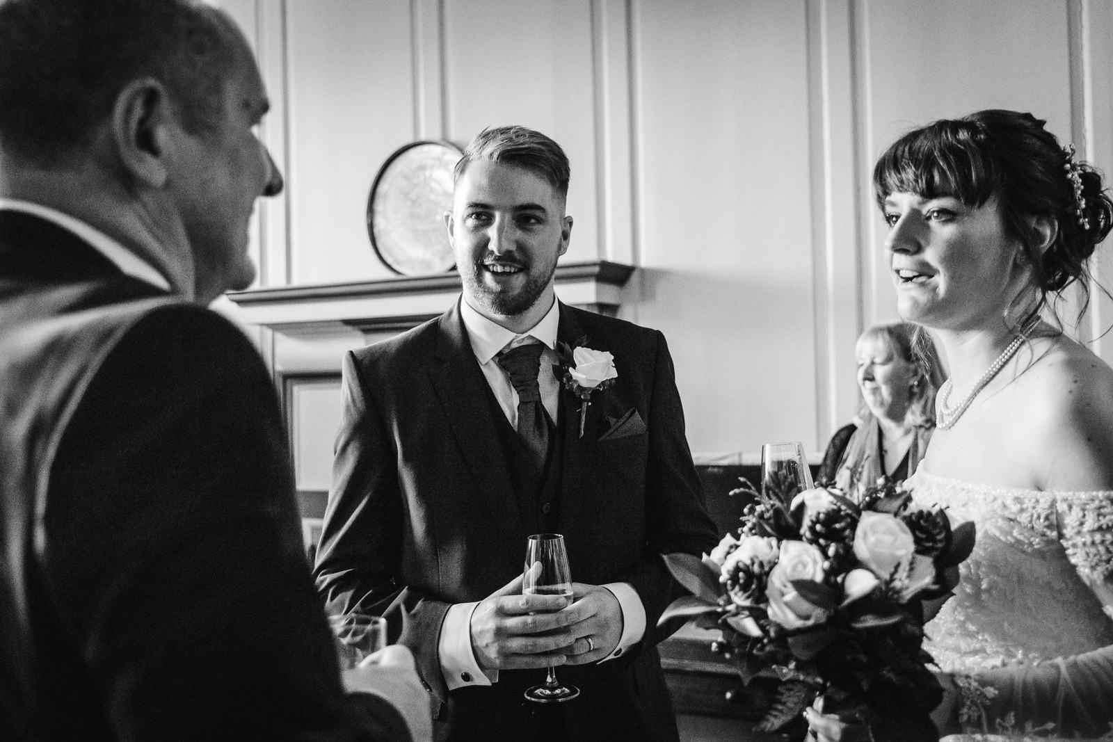 Black-and-white moment of the couple sharing a drink after the ceremony