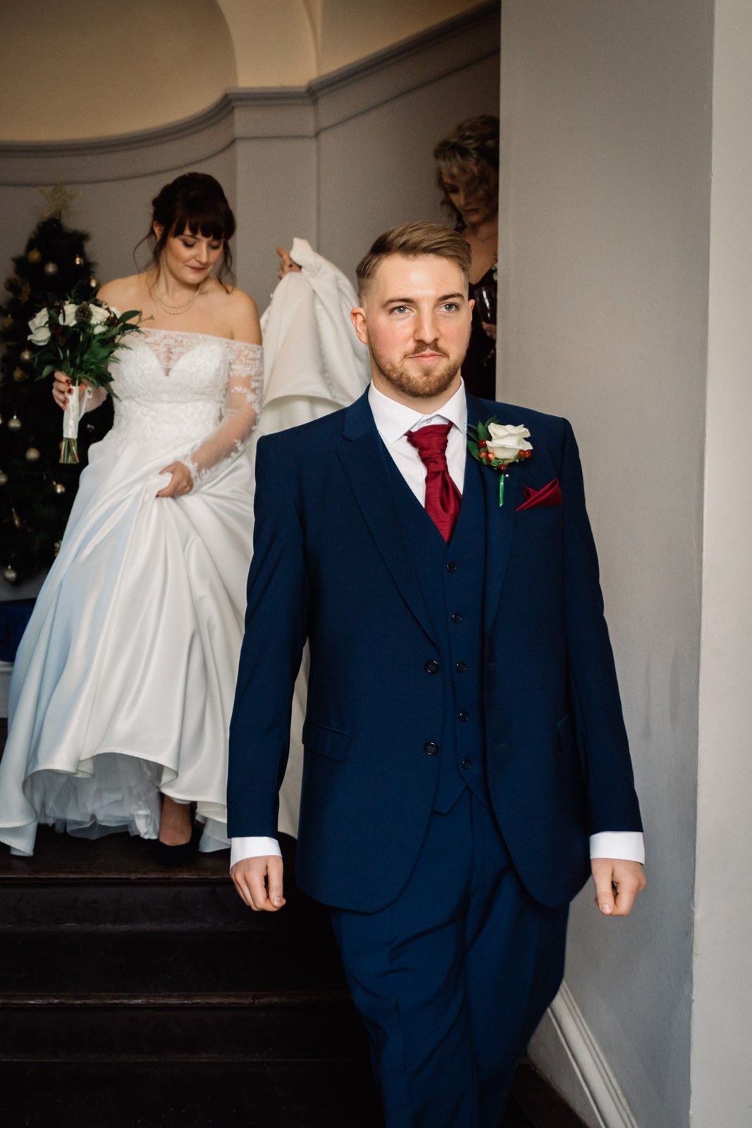 The couple come down the staircase together