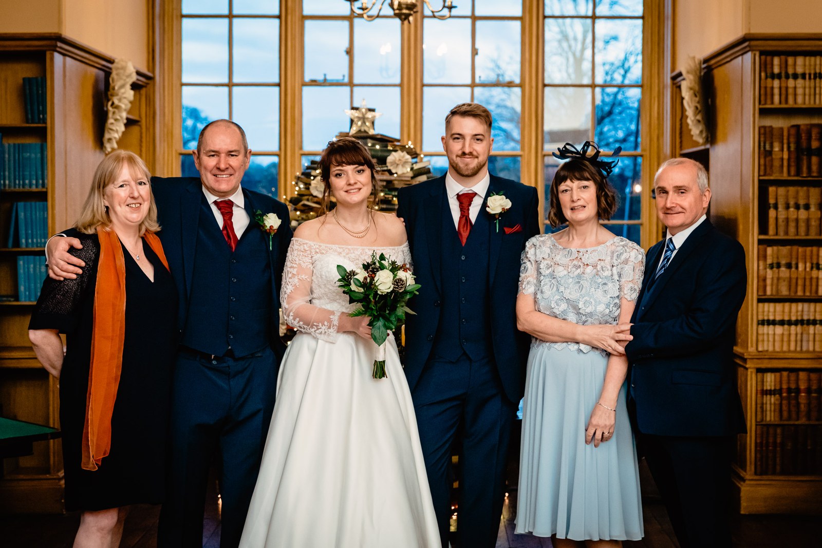 The bride with her family for a group portrait in the library at Delapre Abbey