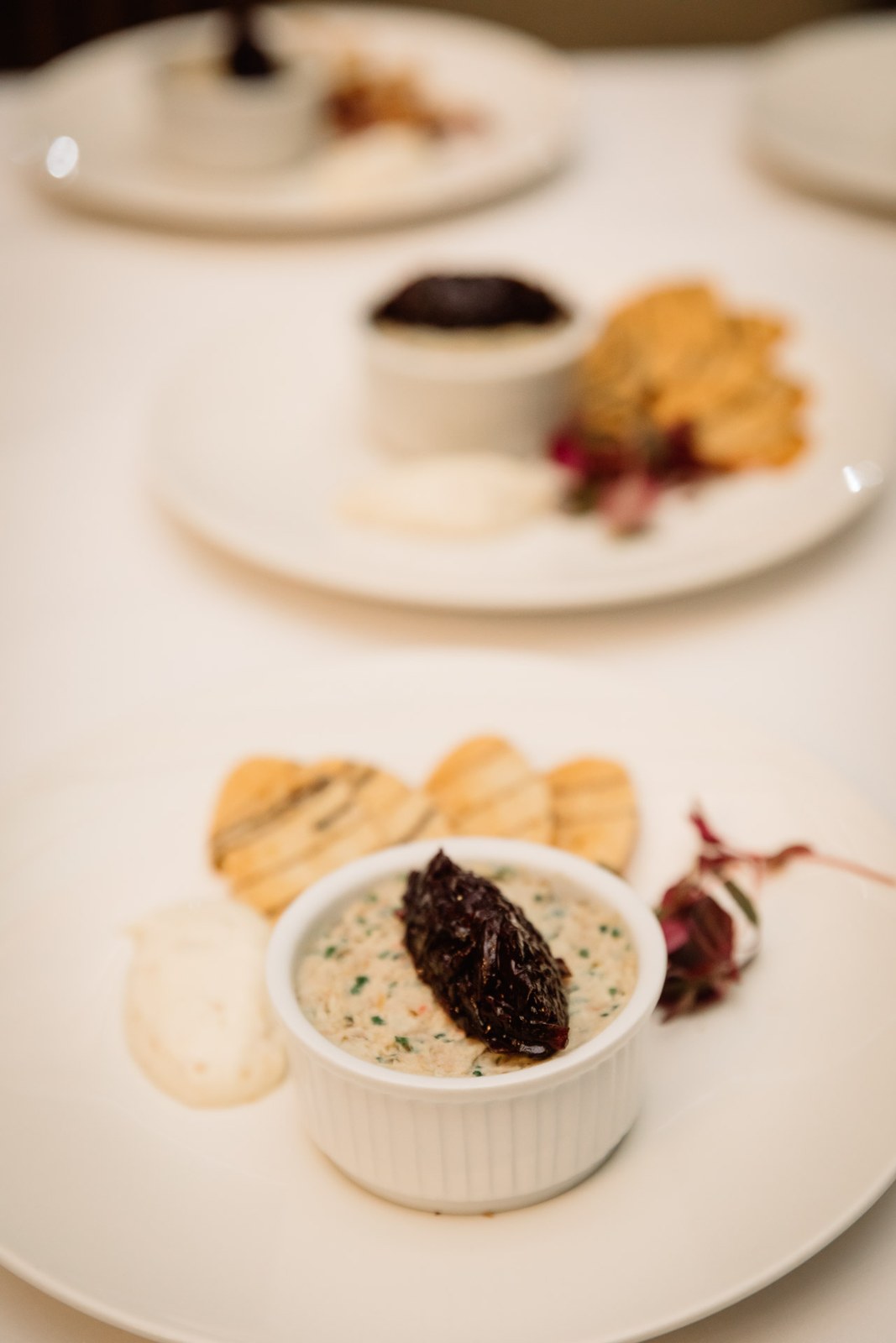 A plated pate starter with toasts and a ramekin