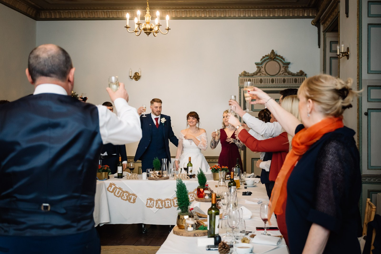 Guests rise with a toast as the couple stand at the top table