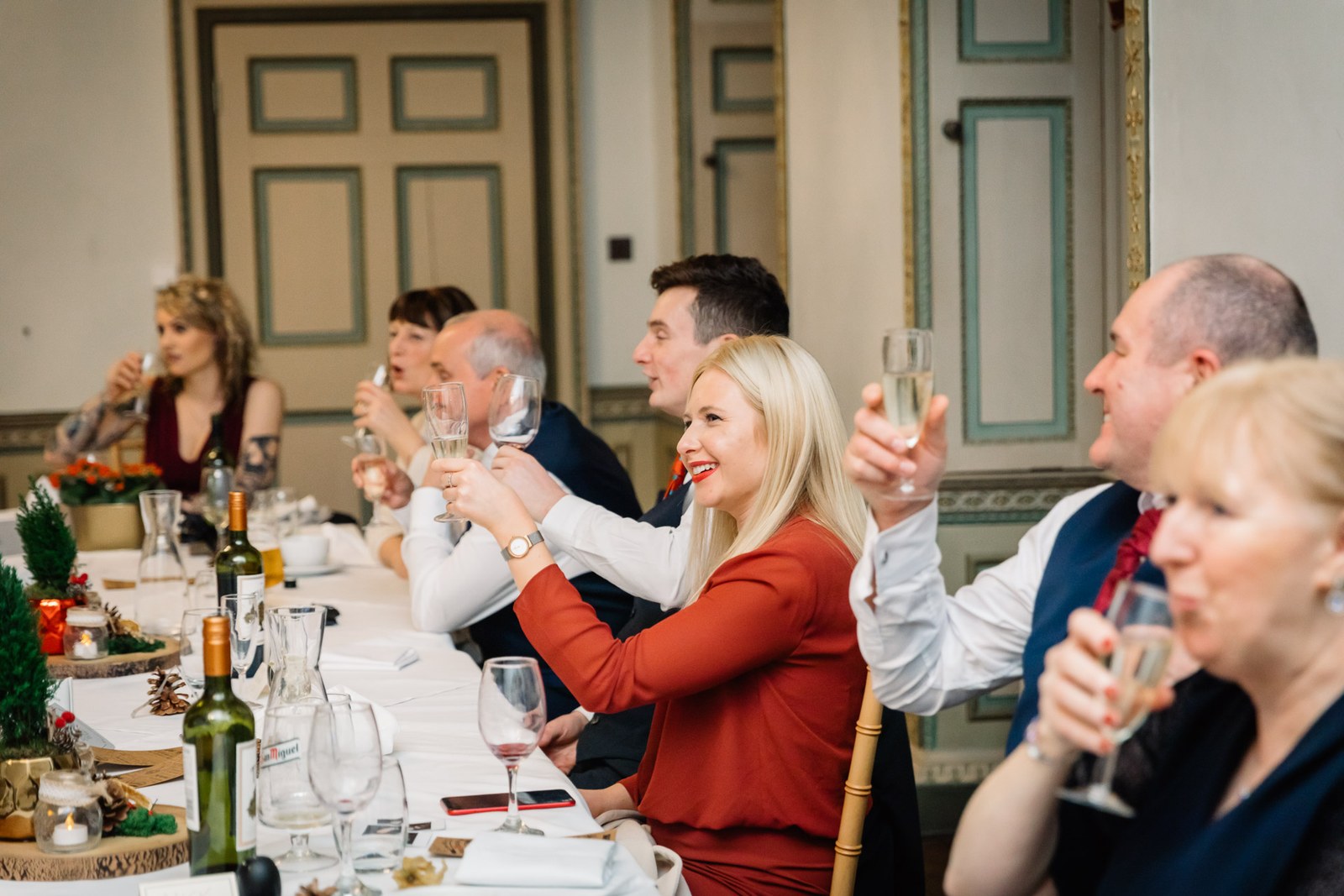 Guests raise a toast around the reception table
