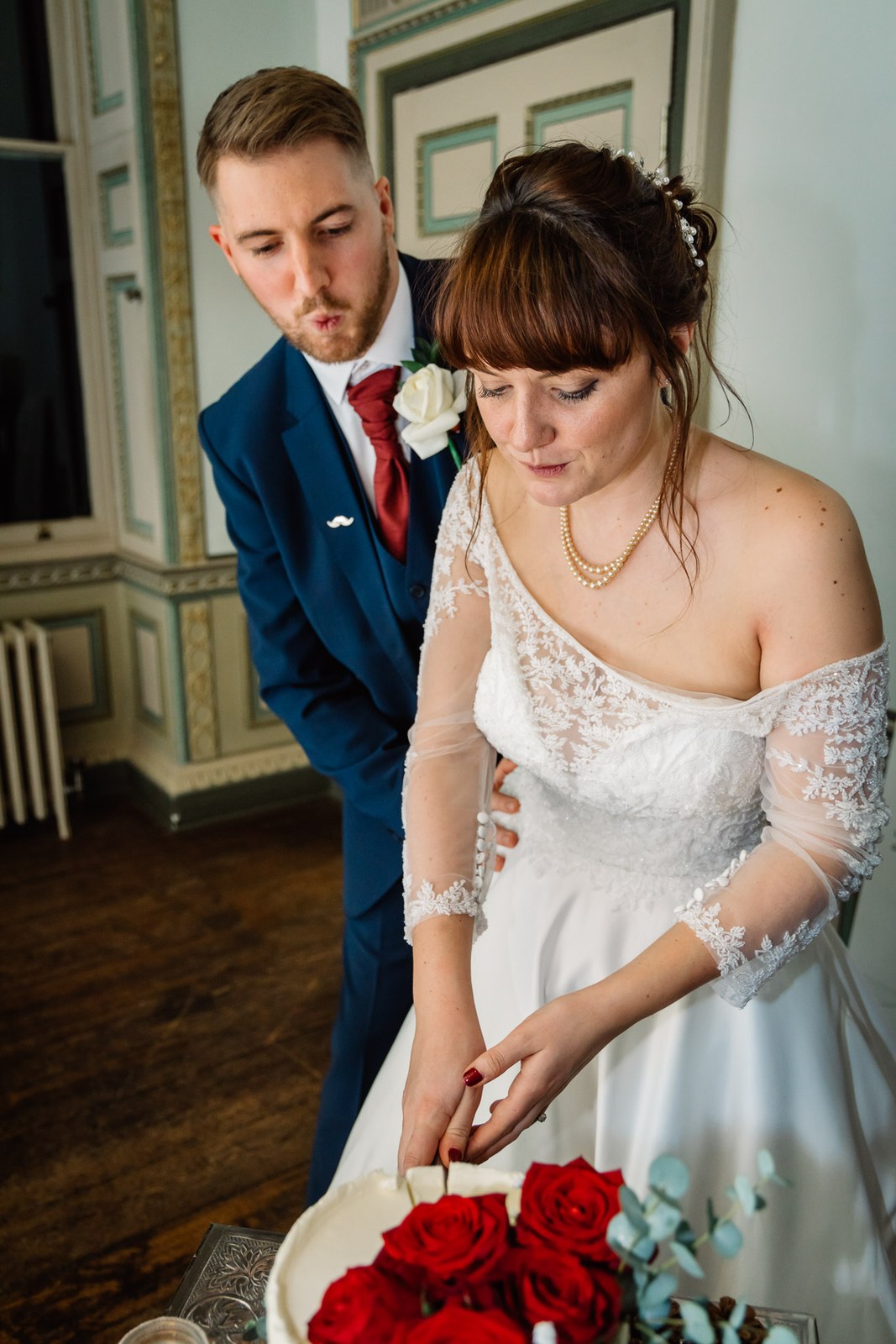 The couple cut their ombre cake trimmed with red roses