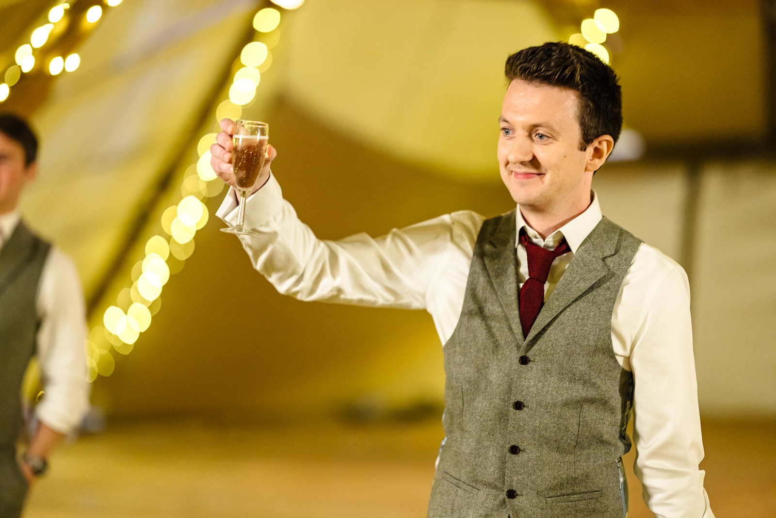 Groom raising his glass for a toast during the tipi speeches