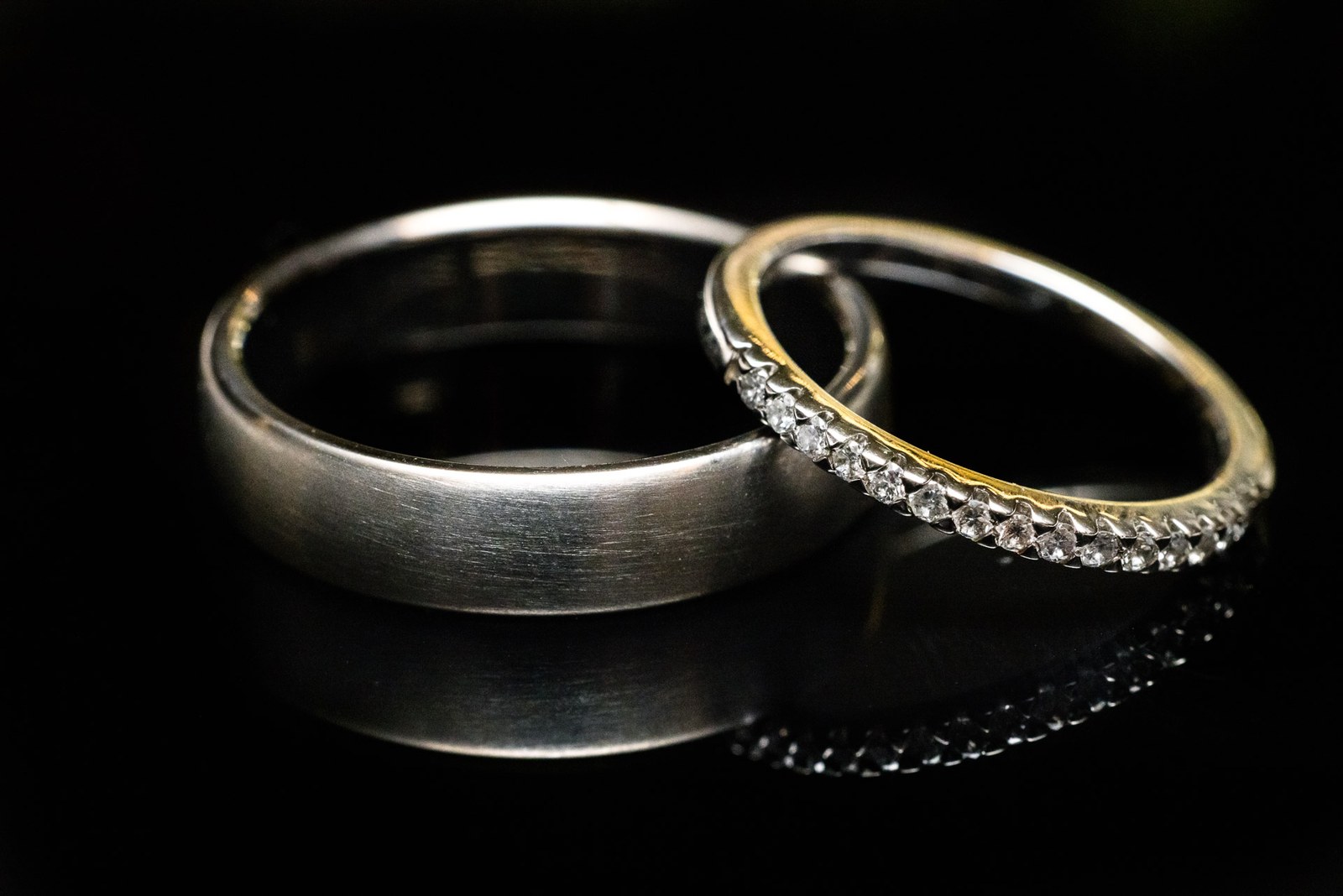 Close-up of the two wedding rings, a plain band beside a diamond-set band