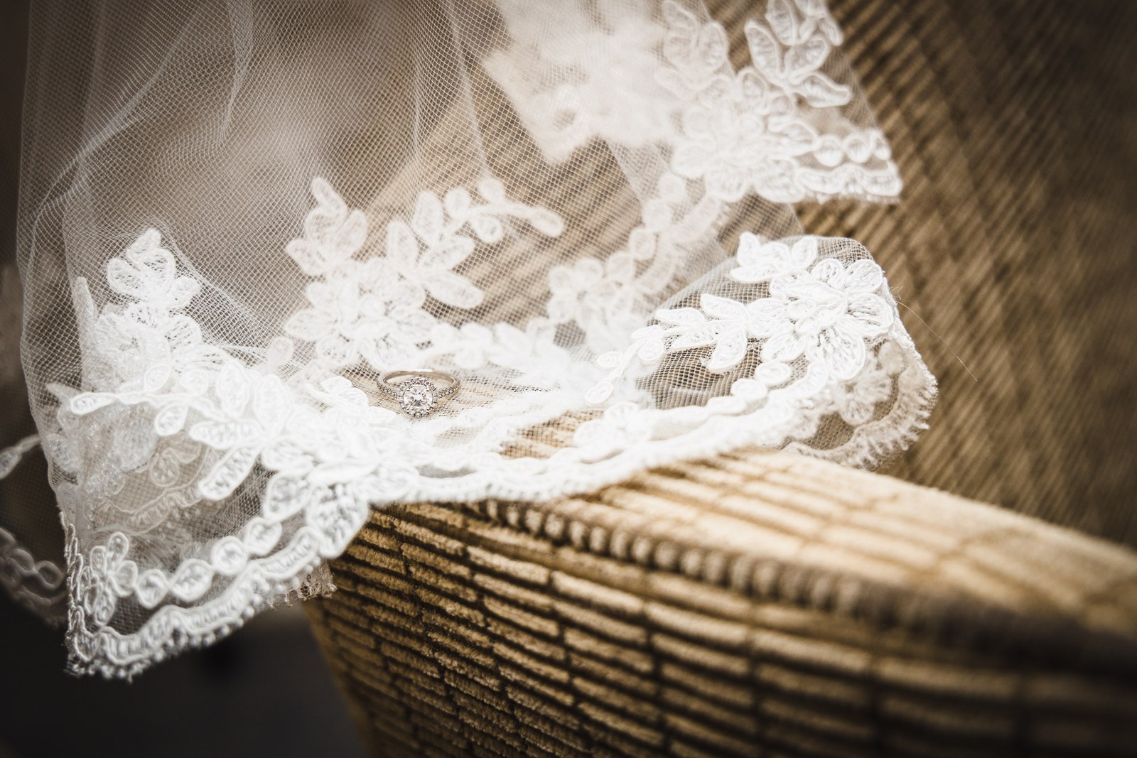 Close-up of the lace-edged veil draped softly over a chair