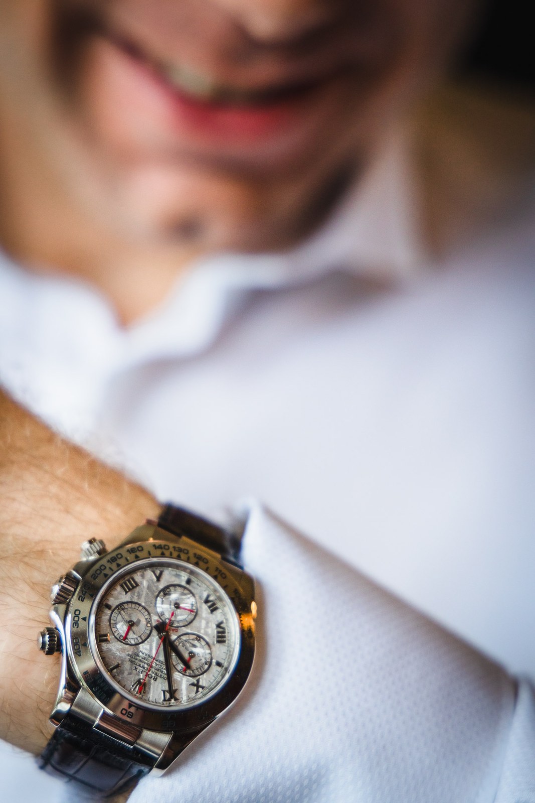 Close-up of a chronograph watch as the groom fastens his shirt cuff