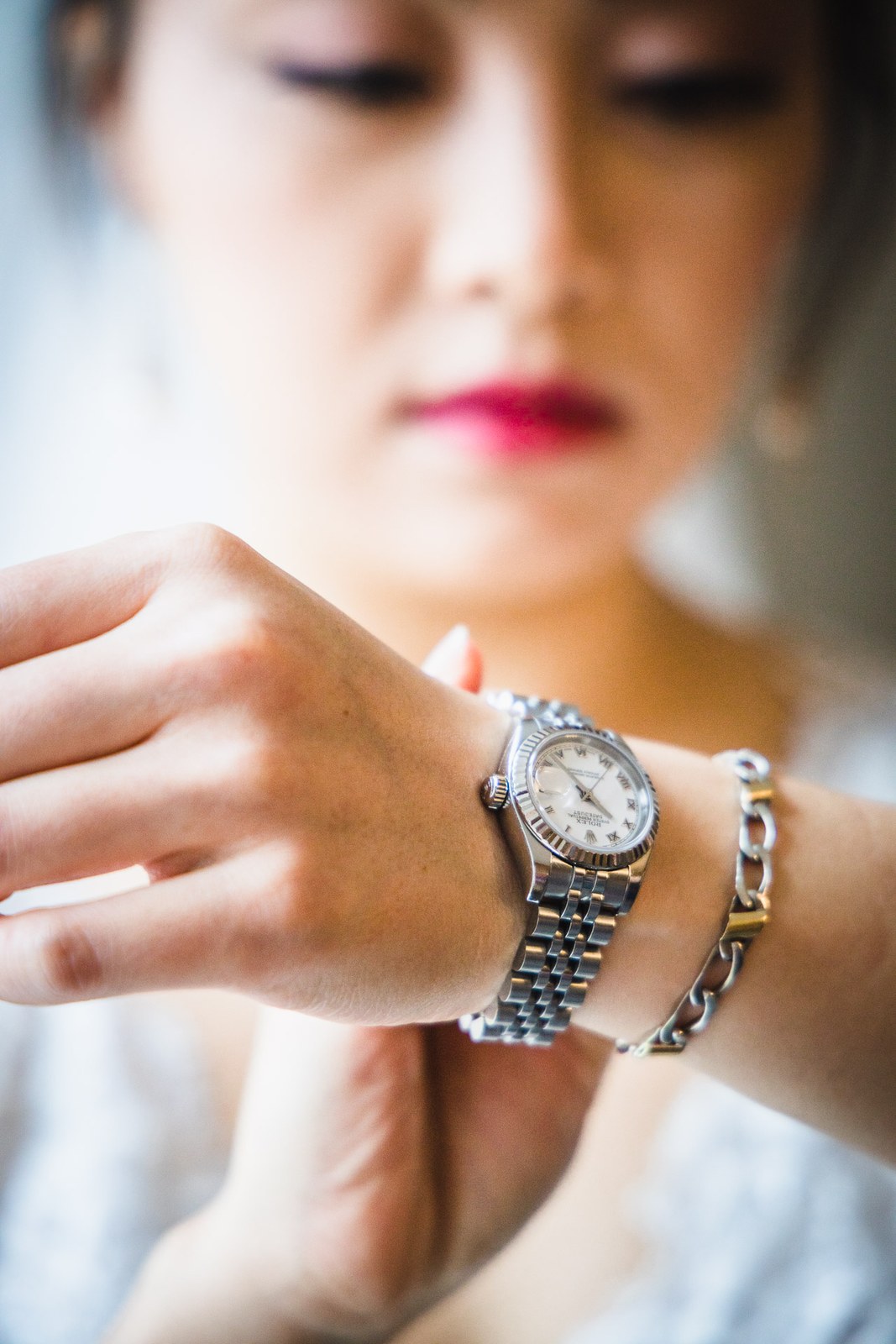 The bride checking her wristwatch, a quiet moment before leaving