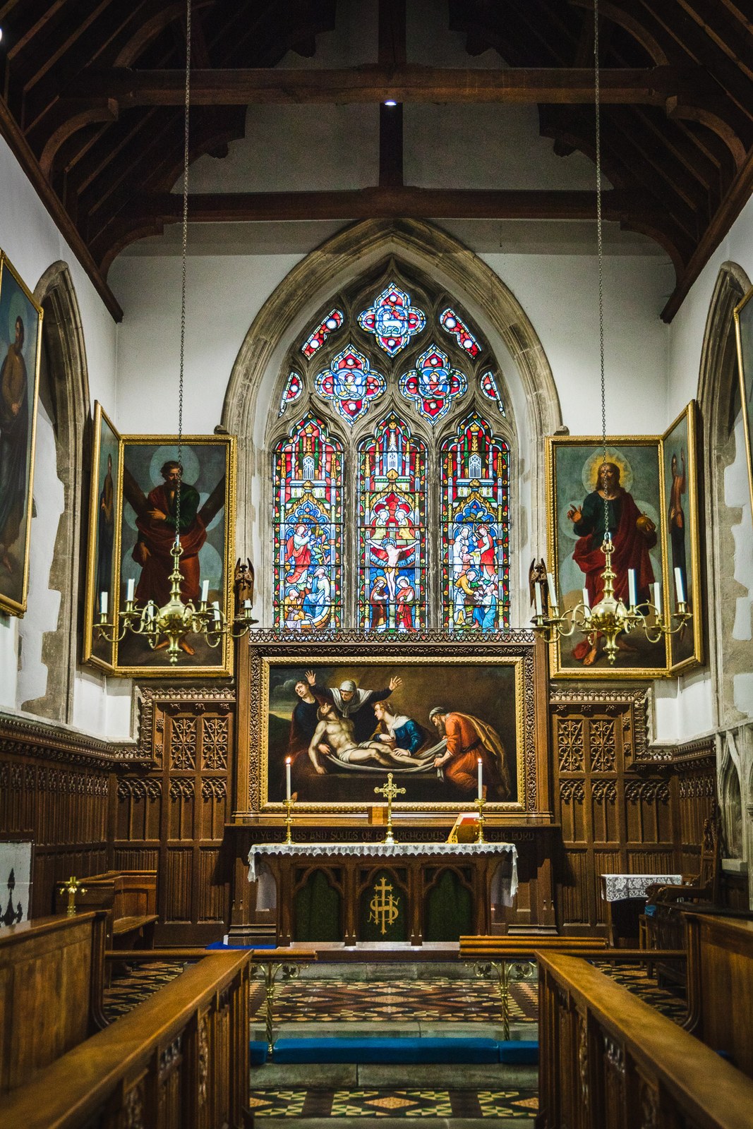 The parish church interior, its stained-glass east window above the altar and reredos