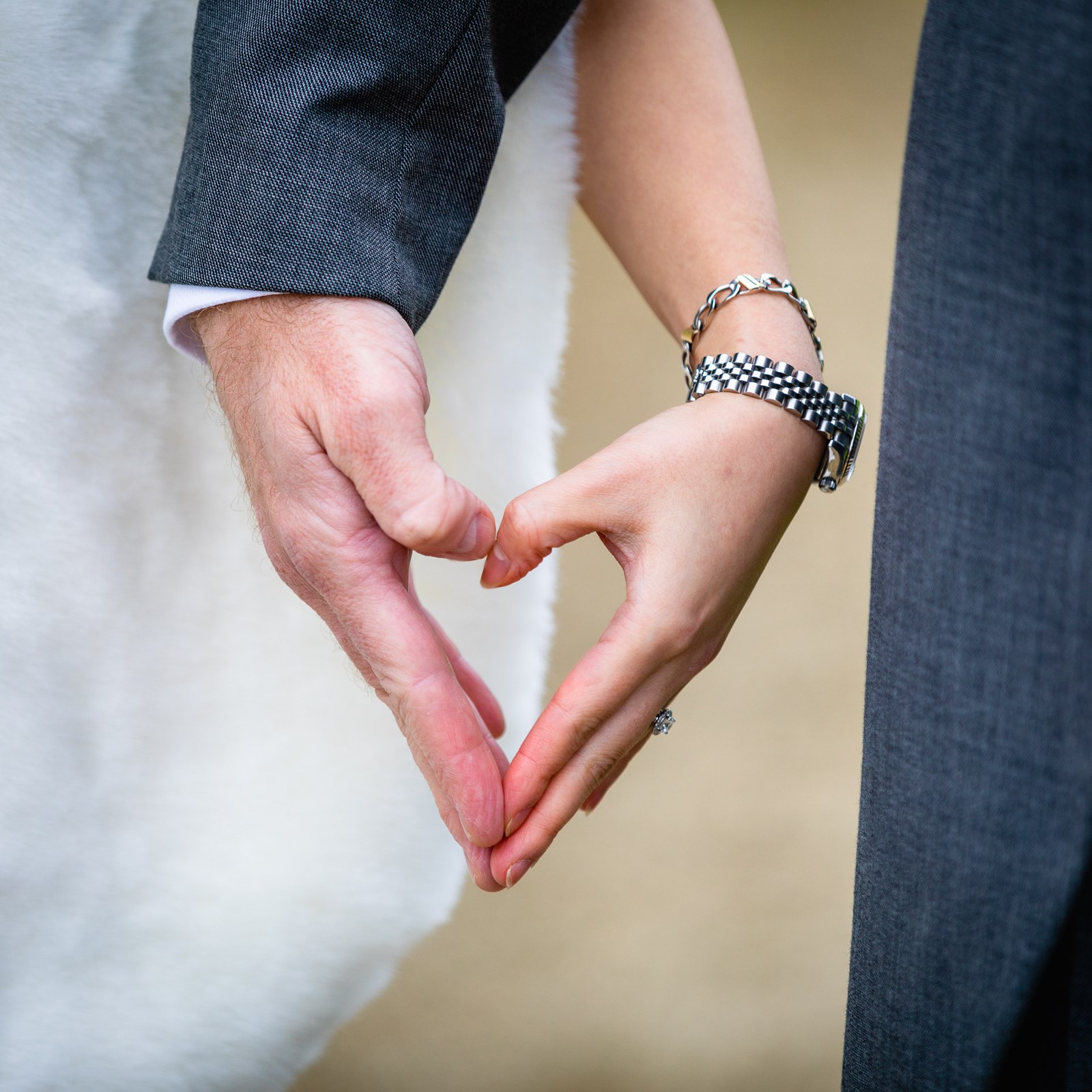 Close-up of the couple's hands forming a heart shape