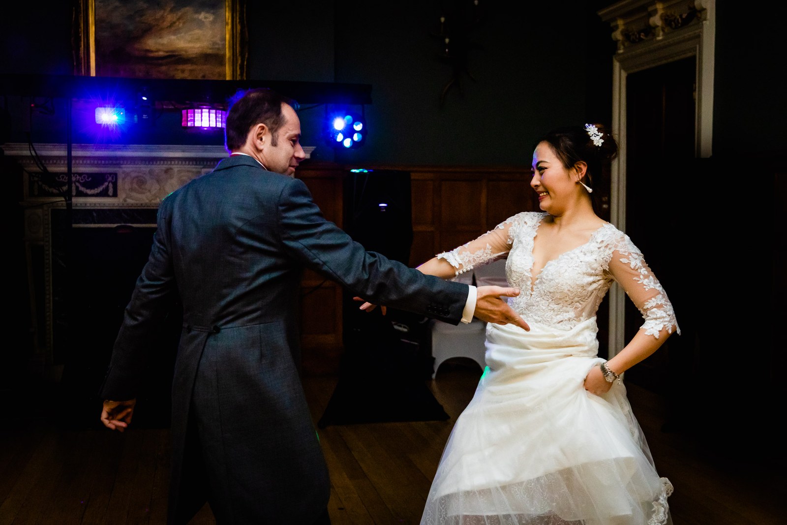 The groom spinning the bride across the floor under the disco lights