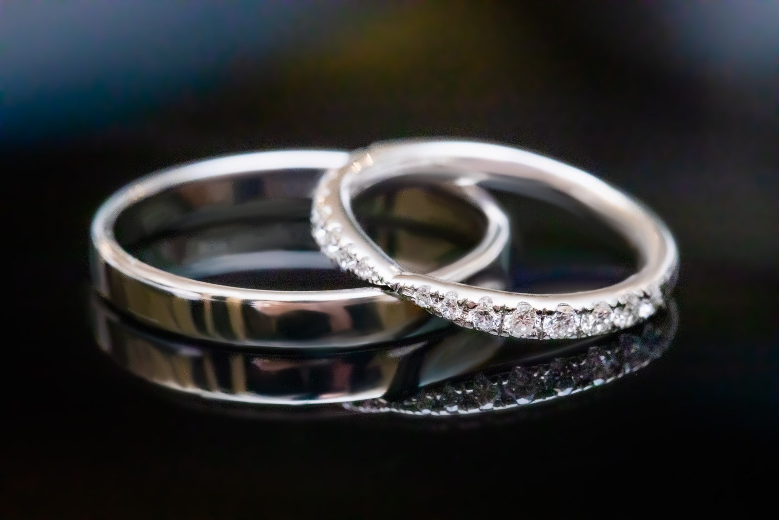 Close-up of the two wedding rings, a plain band beside a diamond-set band