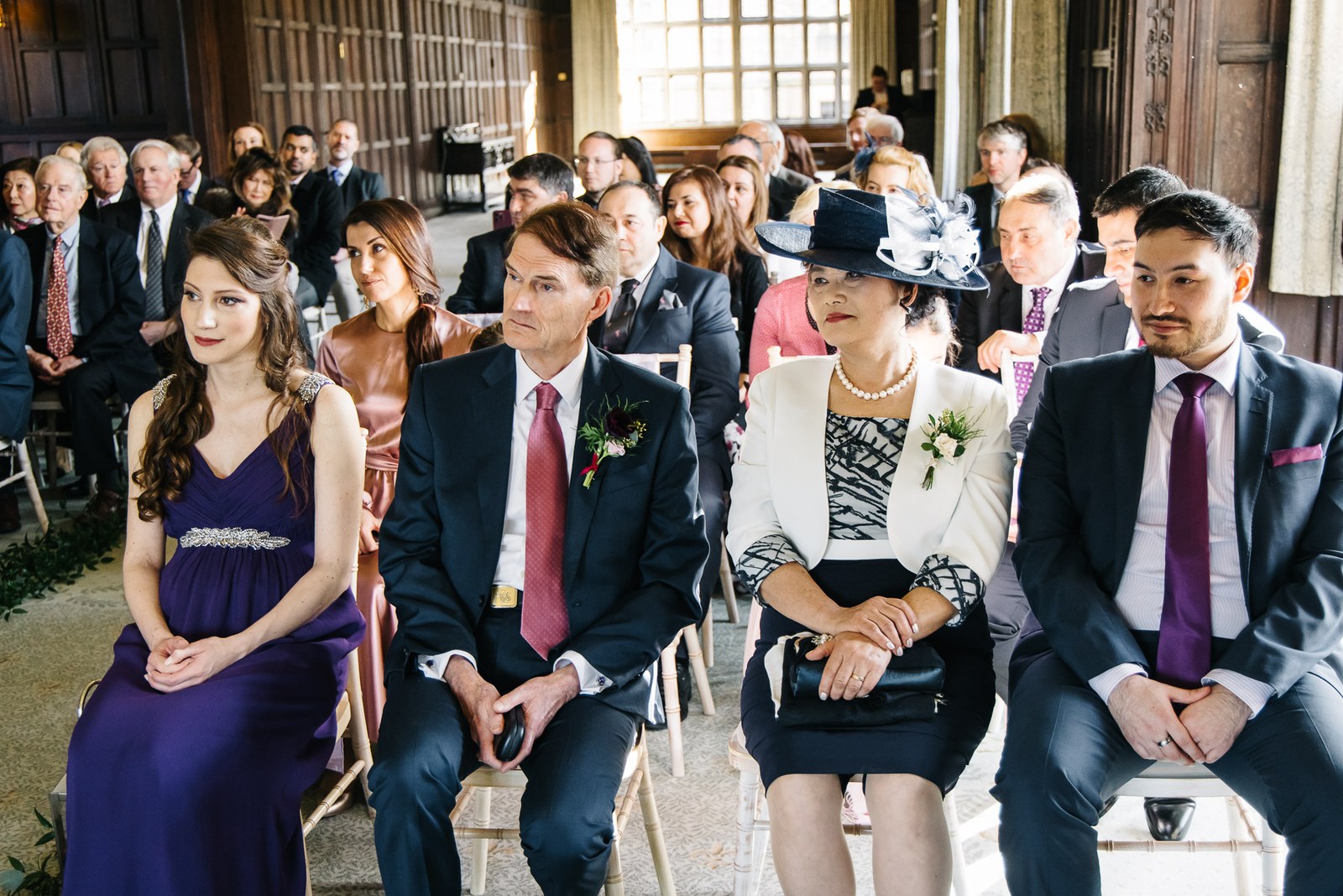 Guests seated in the front row watching the ceremony in the panelled gallery