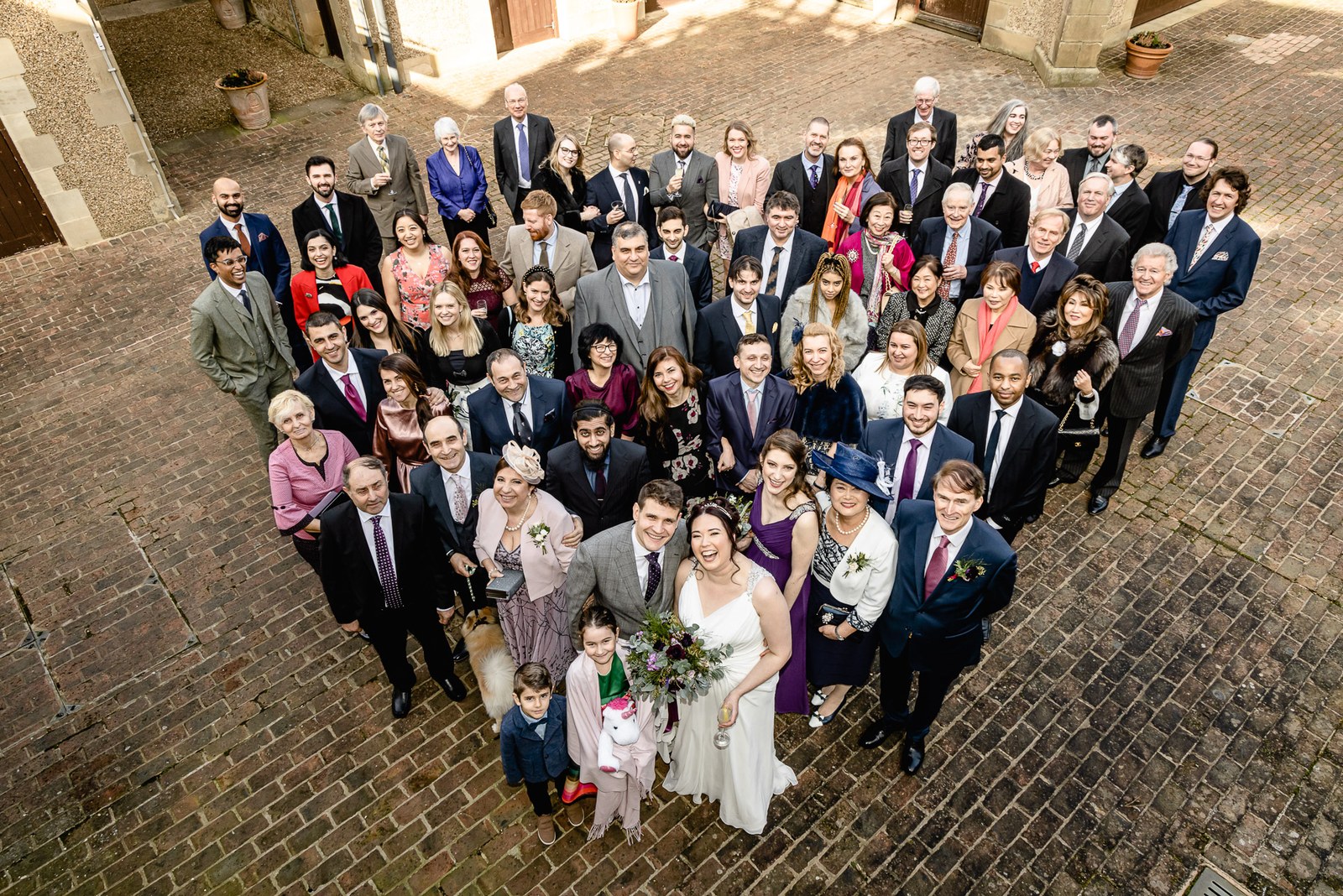 Overhead view of the guests gathered on the brick courtyard at Fanhams Hall