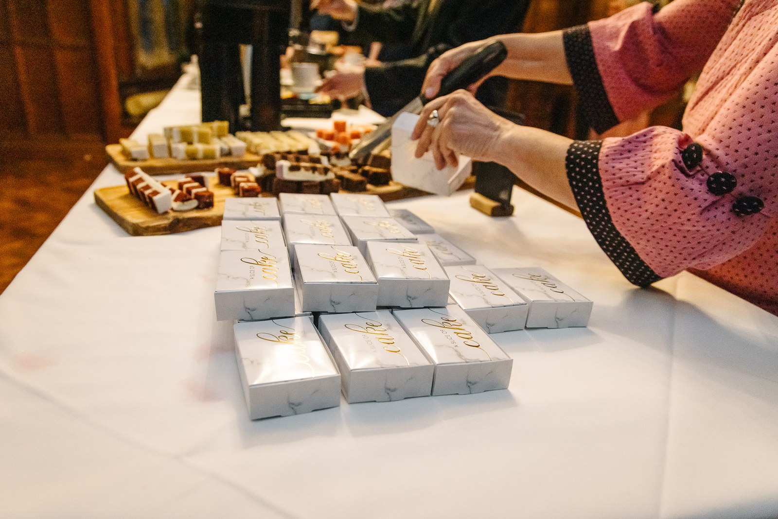Guests helping themselves from the favour and dessert table