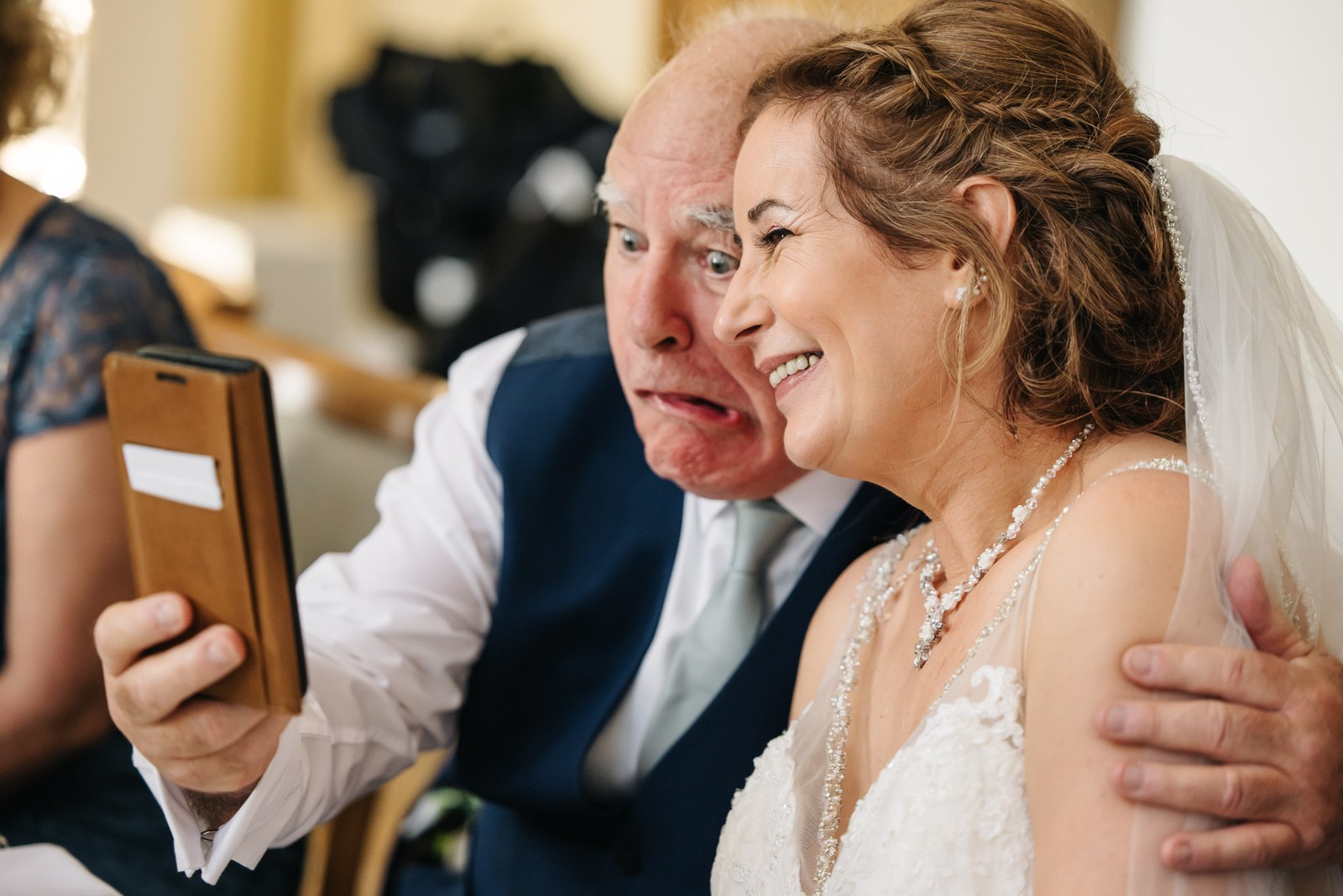 The bride and her father sharing a selfie together