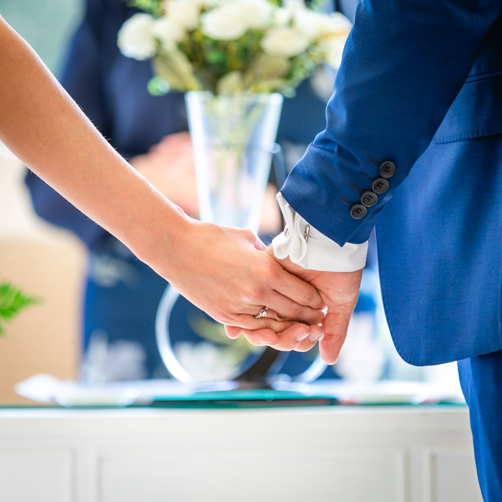Close-up of the couple holding hands during the ceremony