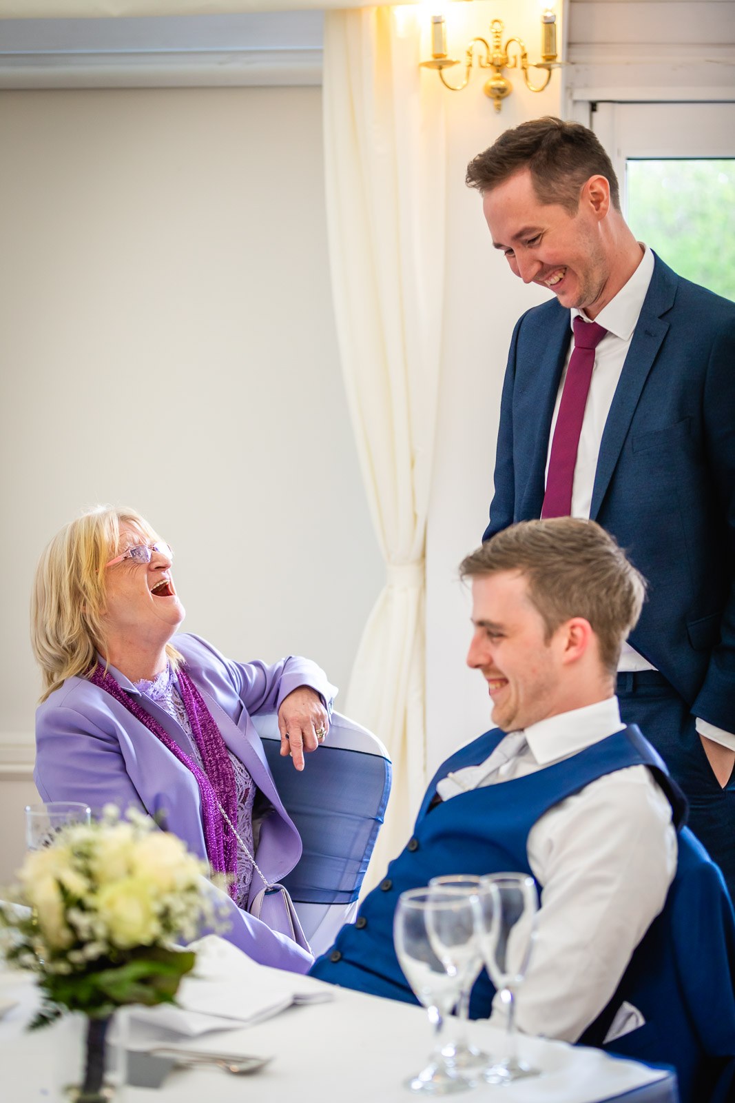 Guests laughing together during the speeches