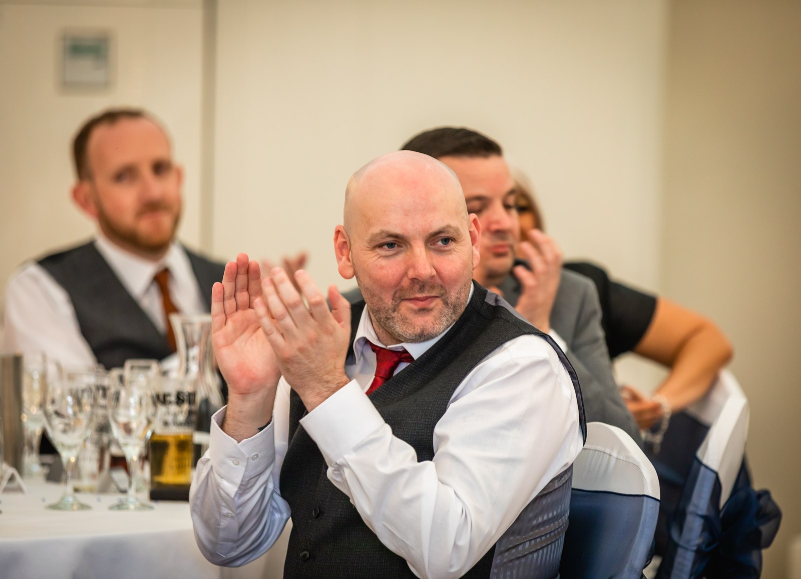 A guest clapping enthusiastically during the speeches
