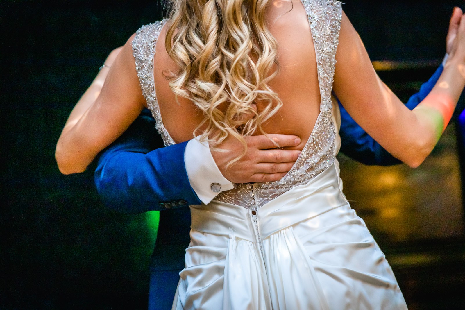 Close-up of the first dance, the groom's hand at the bride's low back