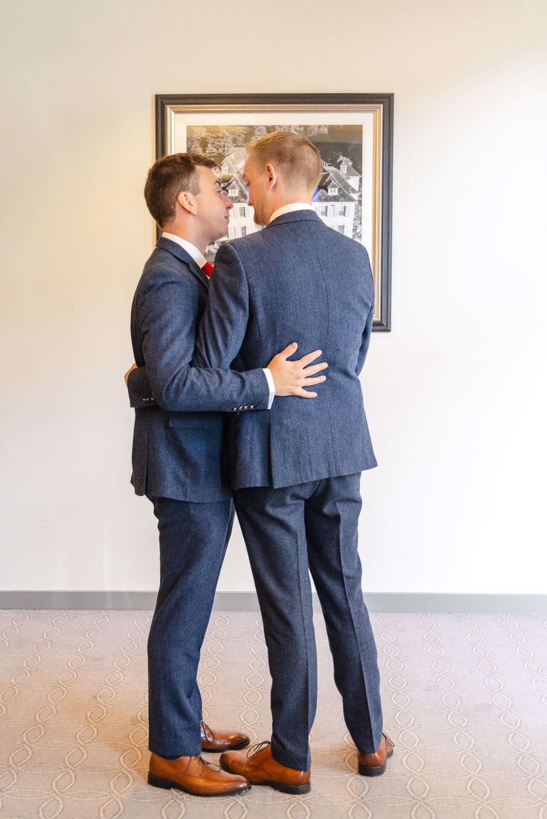 The two grooms sharing a quiet embrace before the ceremony