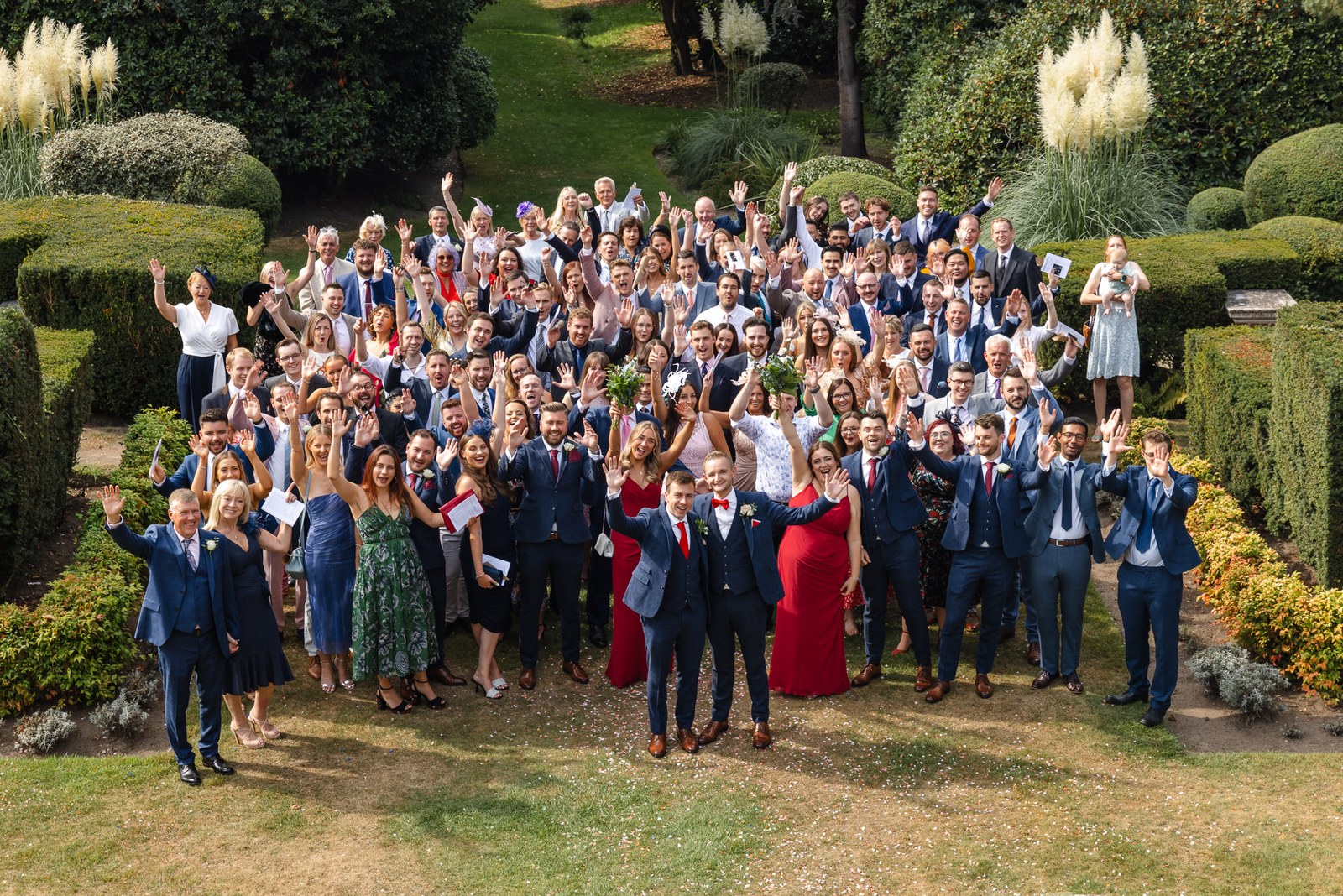 Guests gathered for a group photo in the topiary gardens of Gorse Hill Hotel