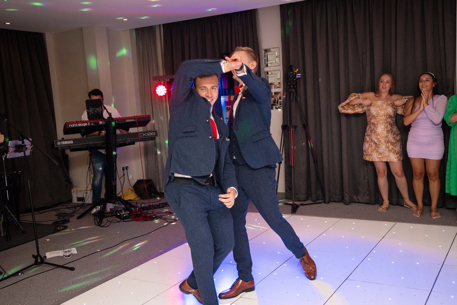 The newlyweds dancing on a sparkling LED floor beneath disco lights