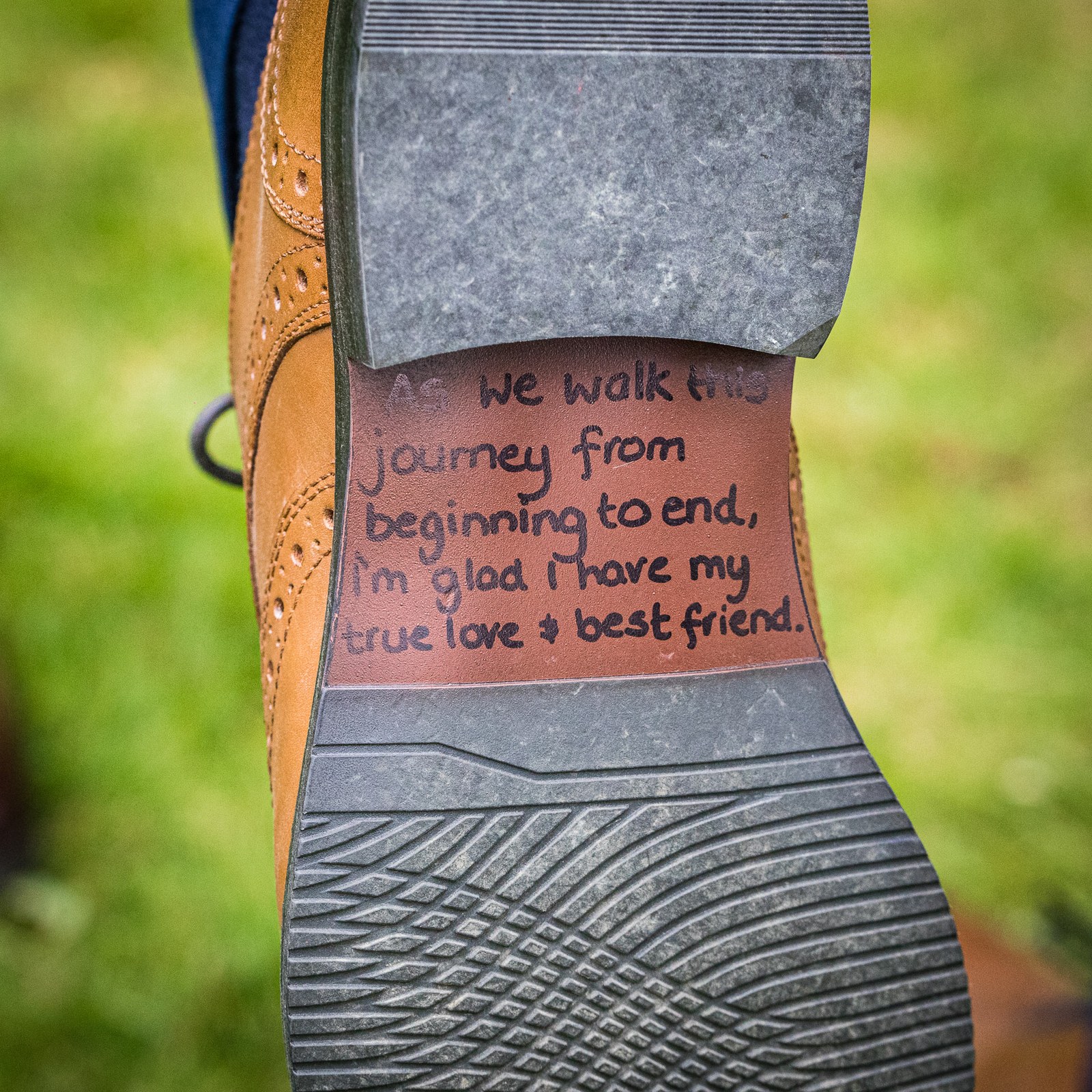 Close-up of the groom's brogue sole inked with a handwritten message