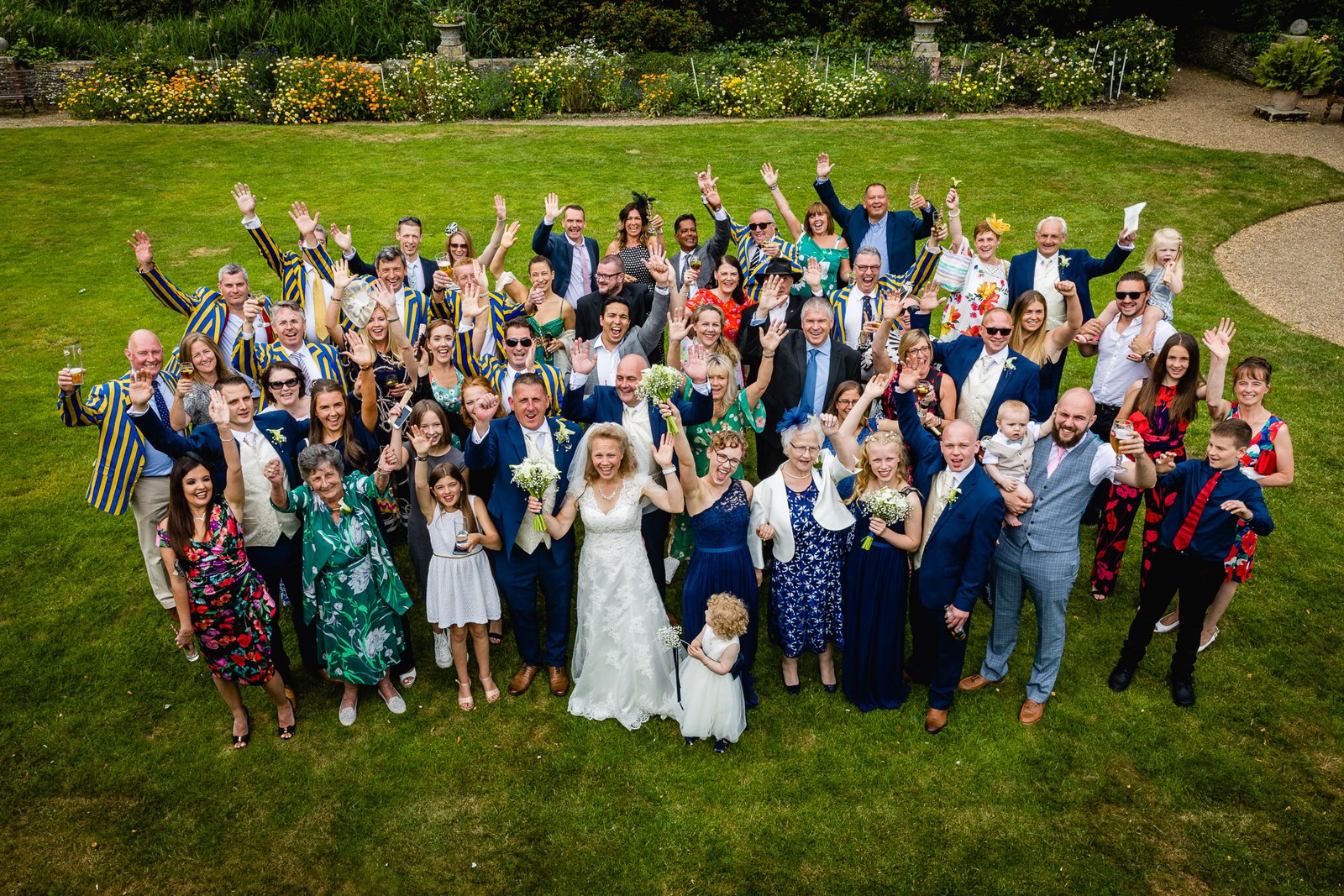 Overhead group photo of all the guests waving on the lawns at Grim's Dyke Hotel