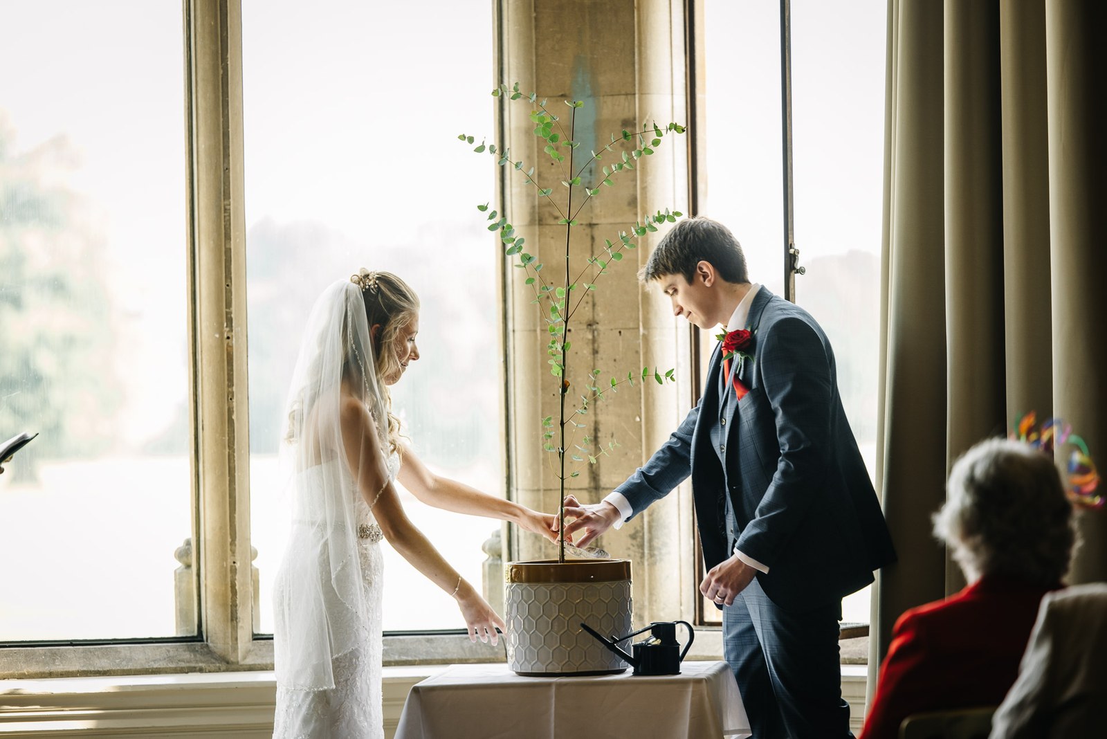 The couple planting a tree together during their ceremony