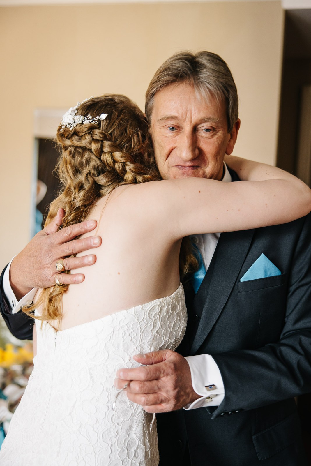 The bride sharing an emotional embrace with her father before the ceremony