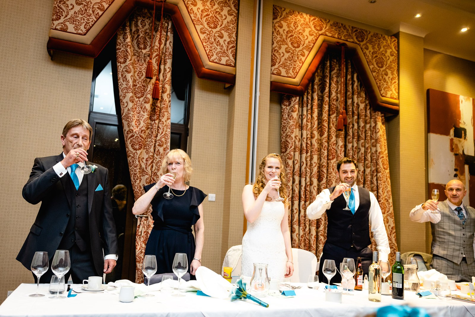 The wedding party raising a toast at the top table