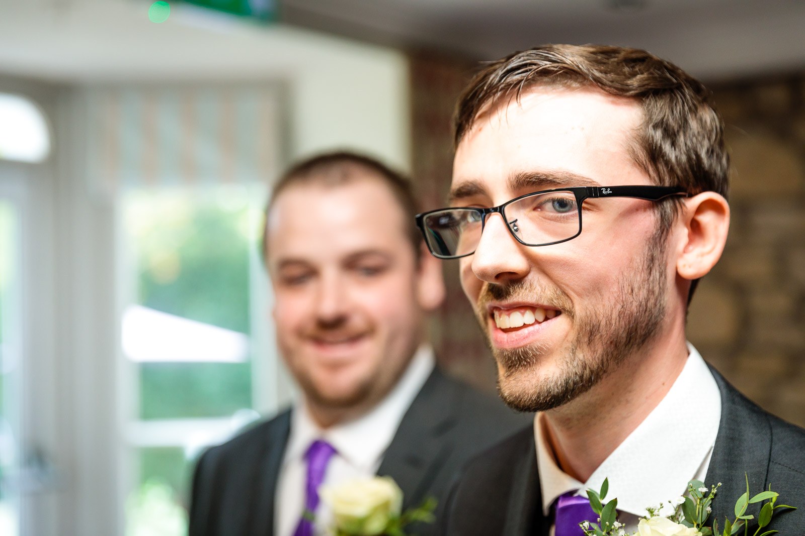 The groom and his best man sharing a smile during the ceremony