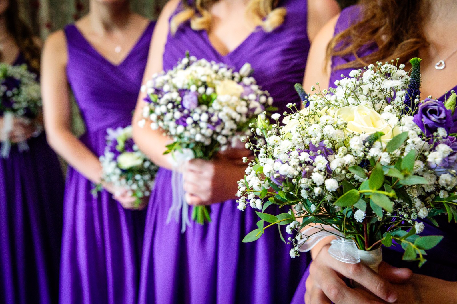 Close-up of the bridesmaids' purple and white gypsophila bouquets