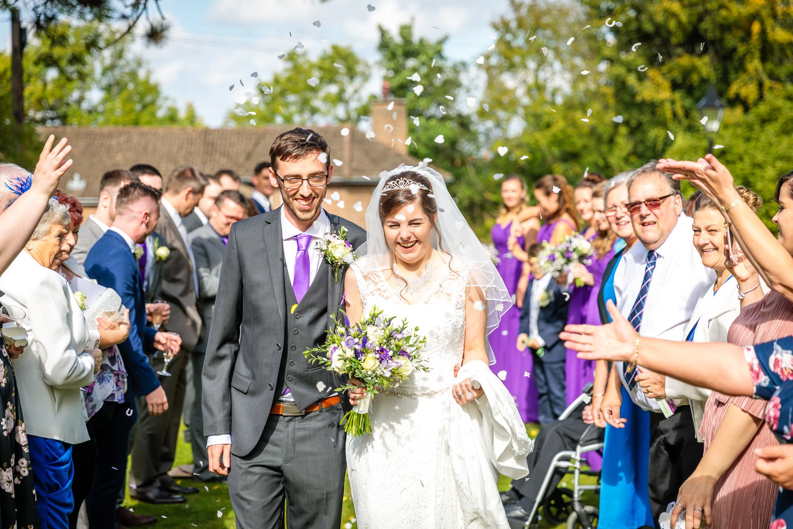 Confetti raining over the newlyweds on the lawn at Hawkwell House Hotel