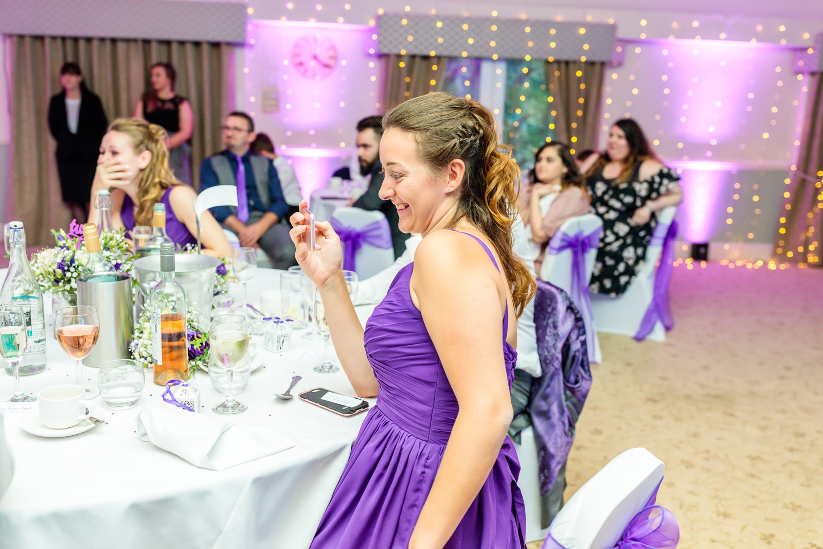 A bridesmaid laughing and reacting during the speeches