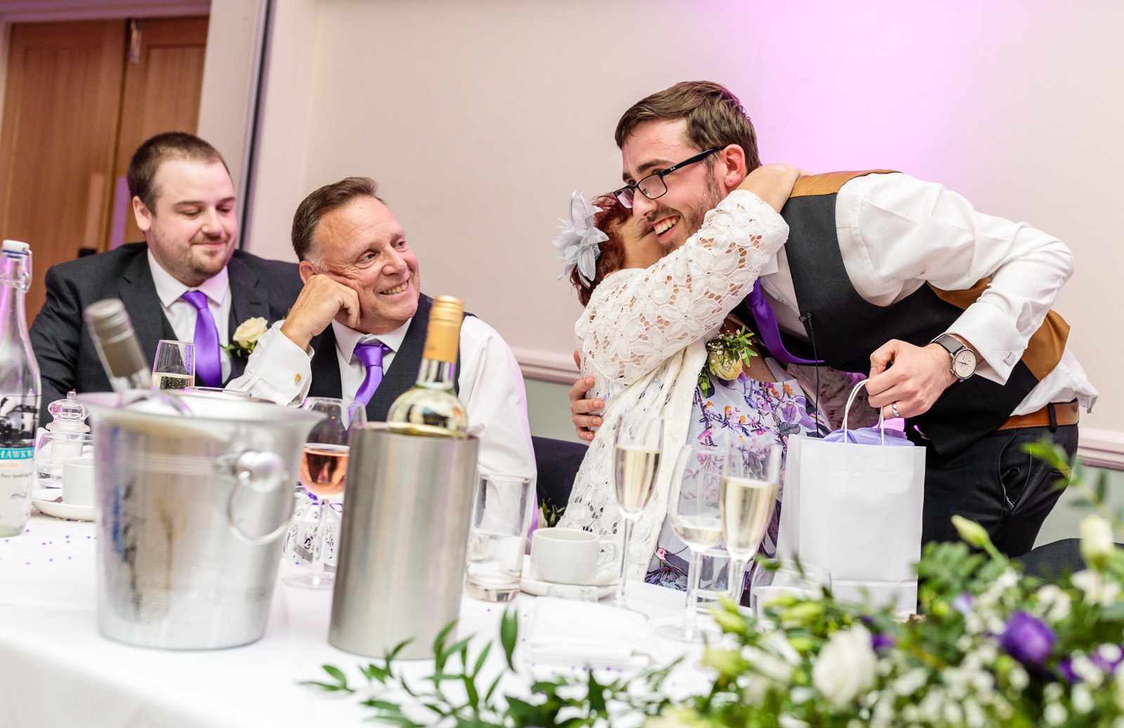 Guests laughing together as gifts are opened during the reception