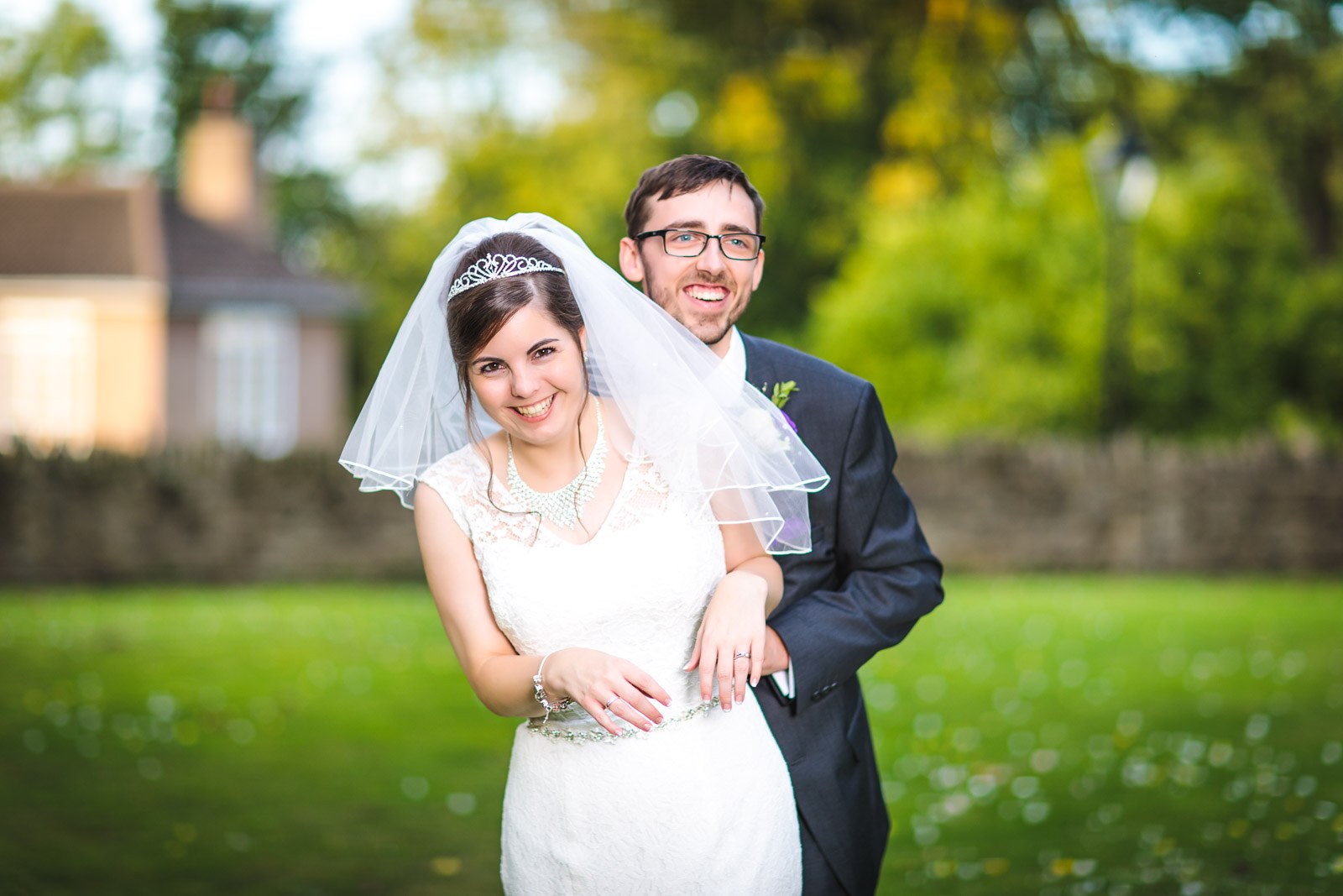 Bride and groom smiling together in the autumn garden