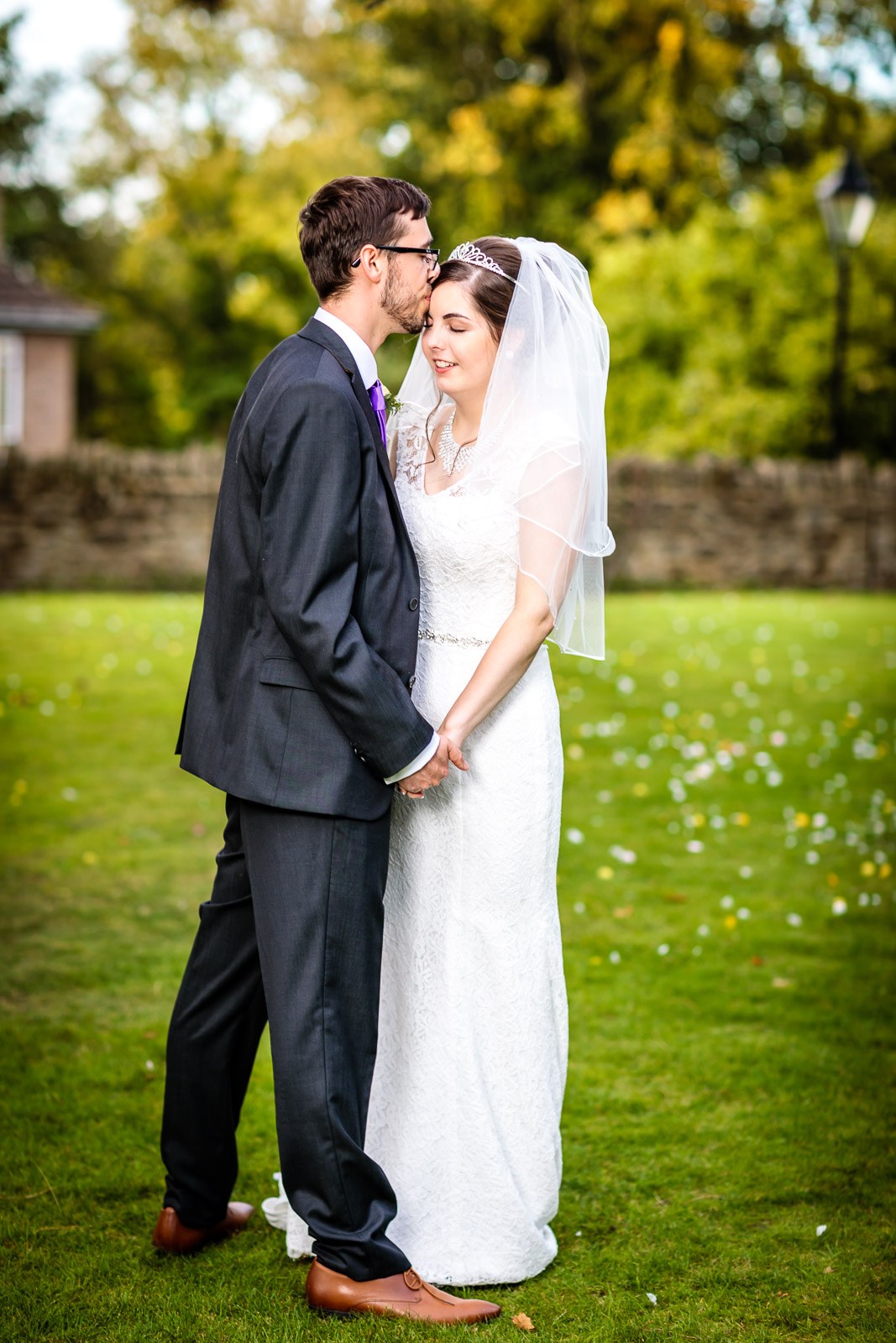 Bride and groom holding hands on the lawn at Hawkwell House Hotel
