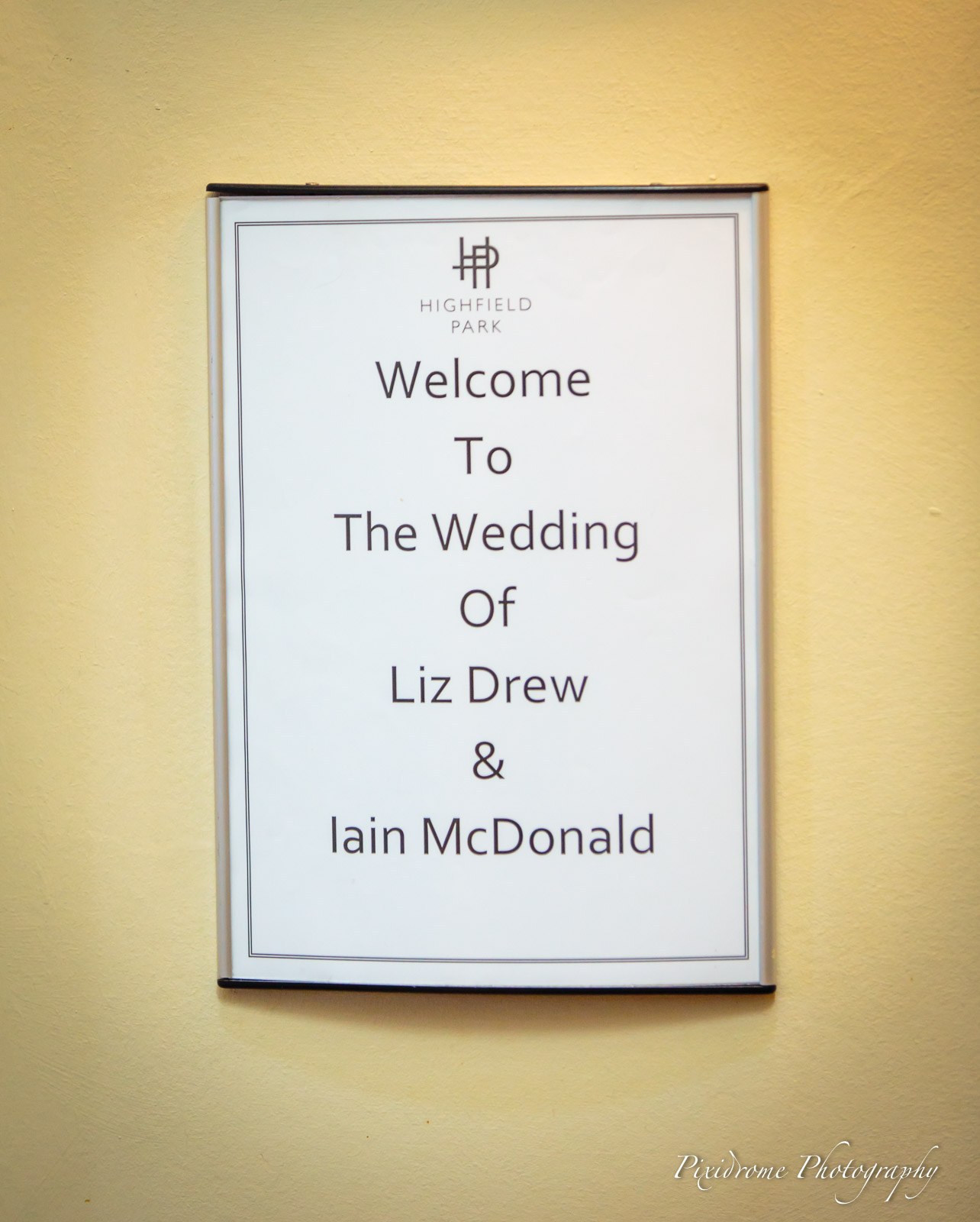 A printed welcome board announcing the couple's wedding at Highfield Park