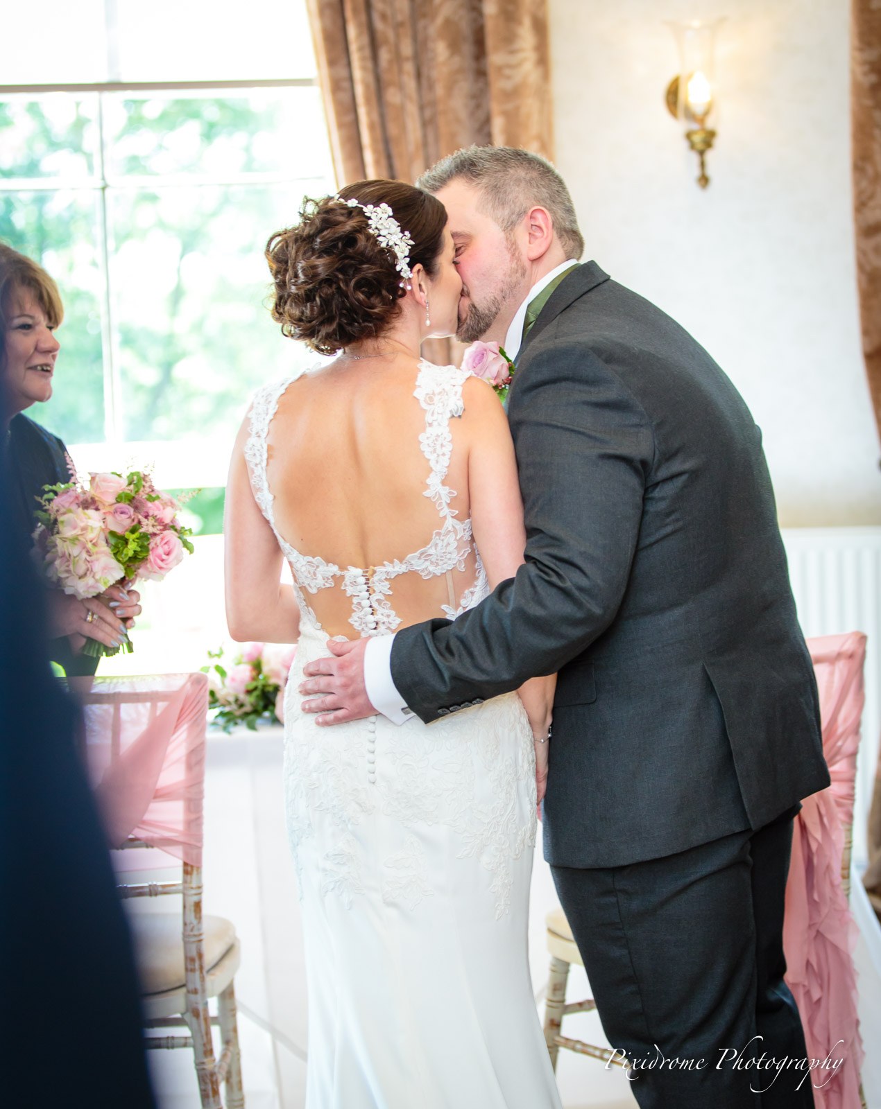 Bride and groom sharing their first kiss as a married couple